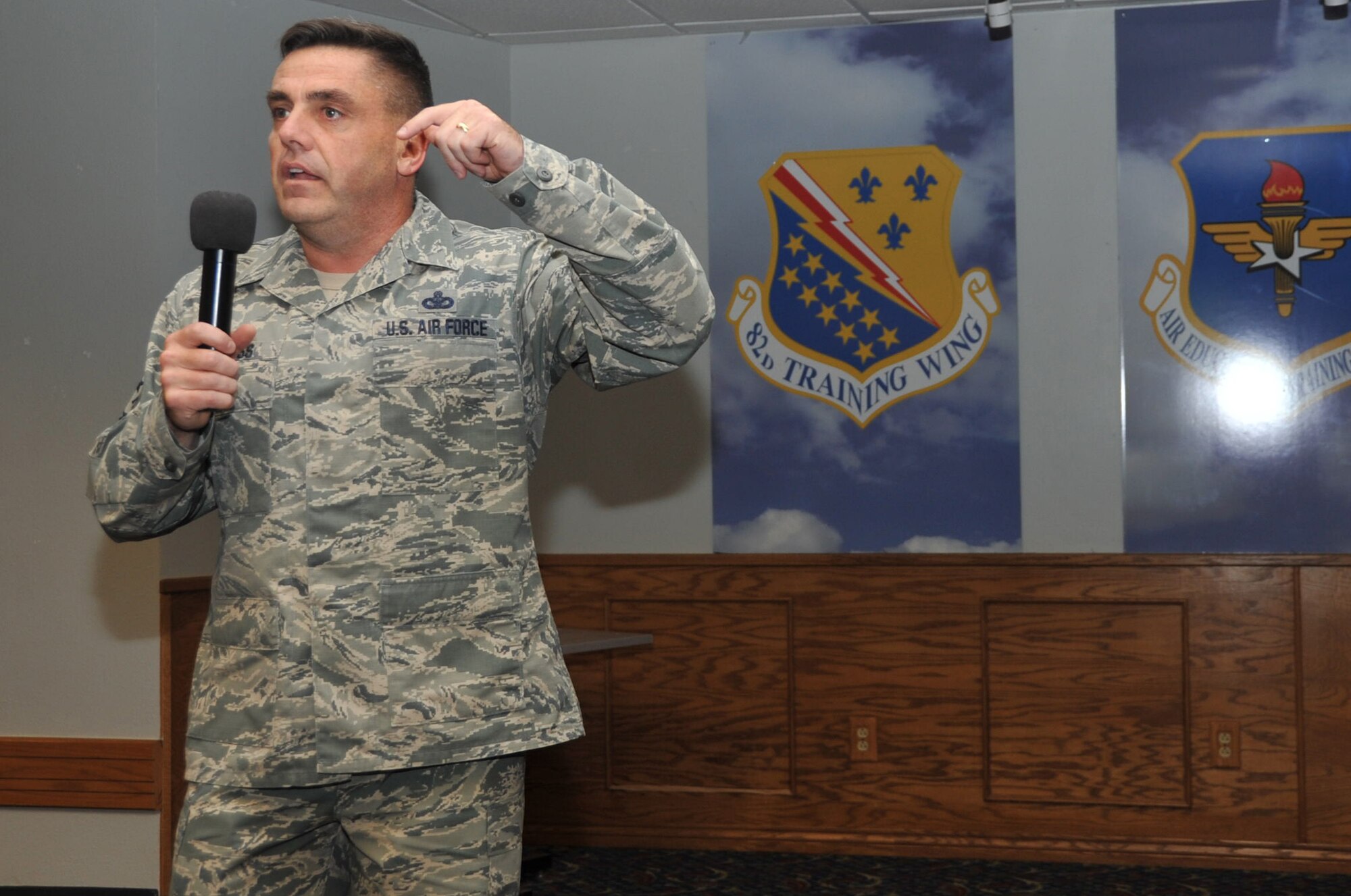 Chief Master Sgt. Charles Burgess III, 82nd Training Wing command chief, speaks during an enlisted all call for permanent part Airmen Sept. 25, 2014, at the Sheppard Club, Sheppard Air Force Base, Texas. Burgess spoke about the newly redesigned Hangar One and how it will be a place for Airmen to kick back and enjoy the Sheppard Club. (U.S. Air Force photo/Airman 1st Class Robert L. McIlrath)