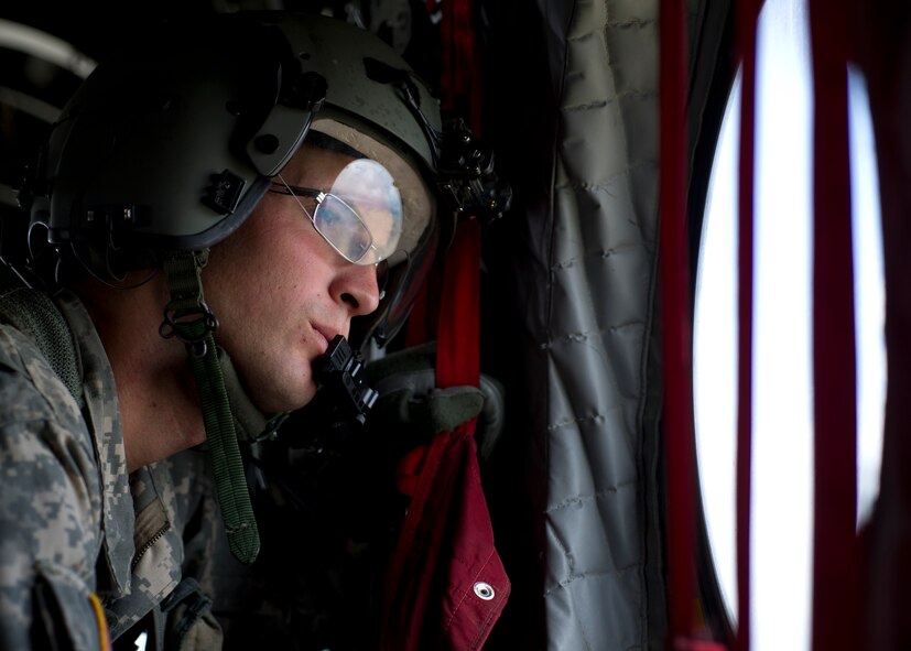 U.S. Army Spc. Joshua Drew, CH-47 Chinook helicopter crew chief, Company B, 6th Battalion, 101st Combat Aviation Brigade, 101st Airborne Division (Air Assault), performs his duties on a U.S. Army CH-47 Chinook Helicopter during a training exercise at Holloman Air Force Base, N.M., Sept. 23. Soldiers from the 101st Airborne Division use the Holloman and White Sands Missile Range training ranges to conduct a Hostile Environment Medical Training Course, designed specifically for Close Protection Operations during deployments to high threat regions throughout the world. (U.S. Air Force photo by Senior Airman Leah Ferrante/Released)