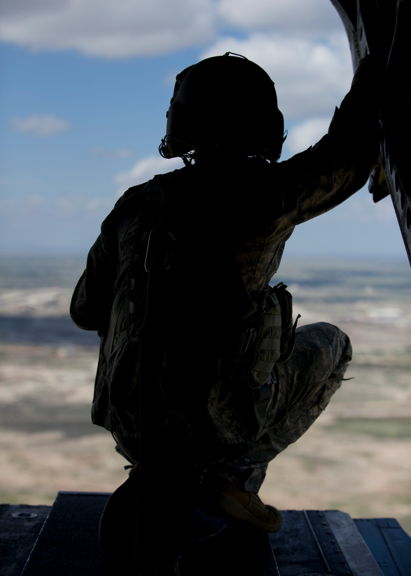 U.S. Army Spc. Joshua Drew, CH-47 Chinook helicopter crew chief, Company B, 6th Battalion, 101st Combat Aviation Brigade, 101st Airborne Division (Air Assault), lowers the ramp on a U.S. Army CH-47 Chinook Helicopter during a training exercise at Holloman Air Force Base, N.M., Sept. 23. Soldiers from the 101st Airborne Division use the Holloman and White Sands Missile Range training ranges to conduct a Hostile Environment Medical Training Course, designed specifically for Close Protection Operations during deployments to high threat regions throughout the world. (U.S. Air Force photo by Senior Airman Leah Ferrante/Released)