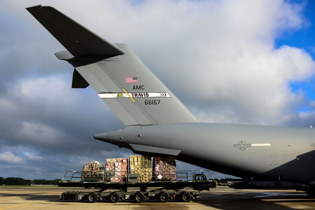 A C-17 Globemaster is loaded with cargo prior to departure at Langley Air Force Base, Va., Sept. 26, 2014. U.S. Air Force Airmen assigned to the 633rd Medical Squadron deployed to West Africa in support of Operation United Assistance. (U.S. Air Force photo by Senior Airman Kayla Newman/Released)