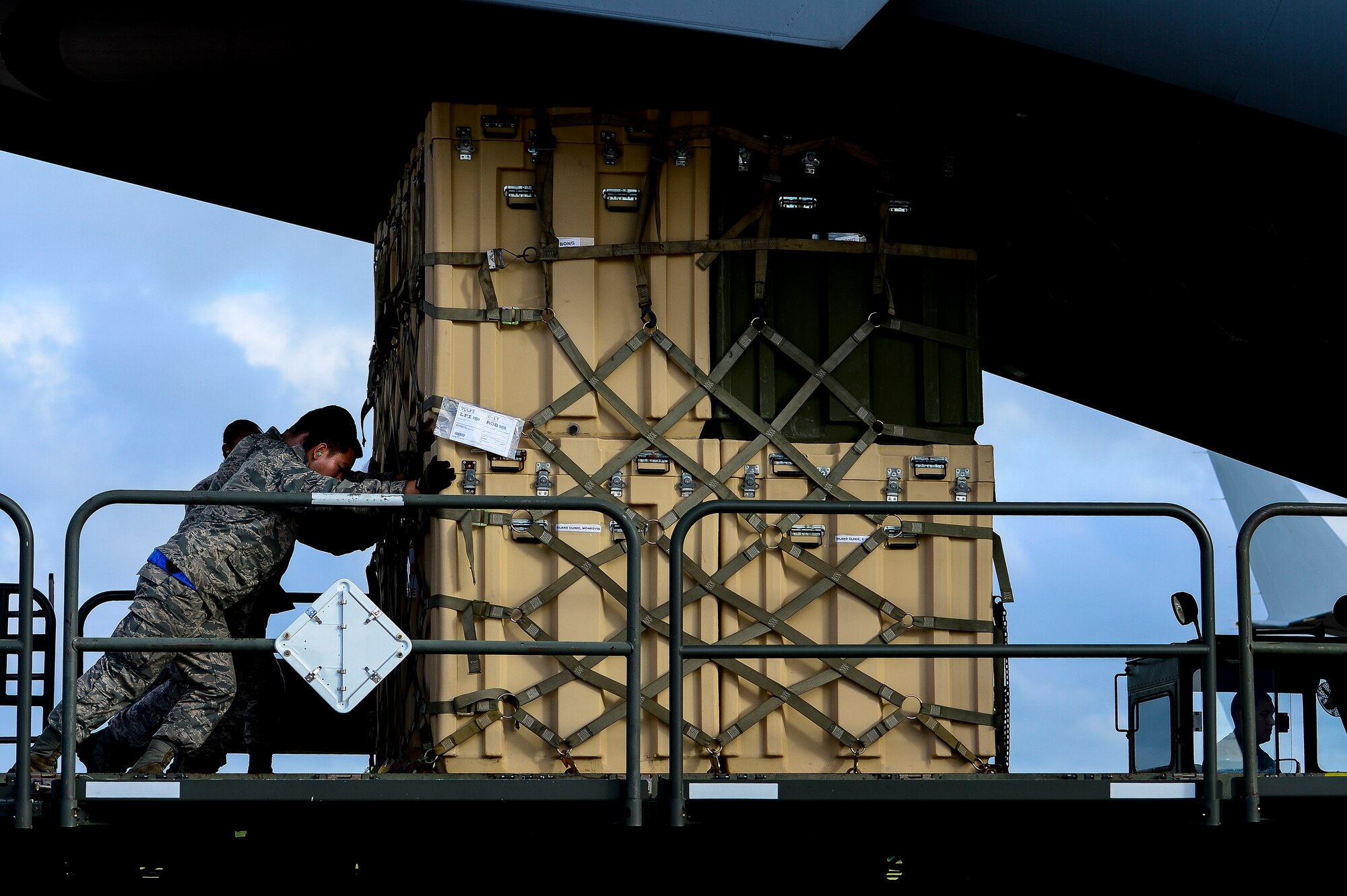 U.S. Air Force Airmen load cargo onto a C-17 Globemaster at Langley Air Force Base, Va., Sept. 26, 2014. The C-17 was used to ship the Air Force’s Expeditionary Medical Support System, a modular and customizable treatment facility designed for austere conditions.  (U.S. Air Force photo by Senior Airman Kayla Newman/Released)