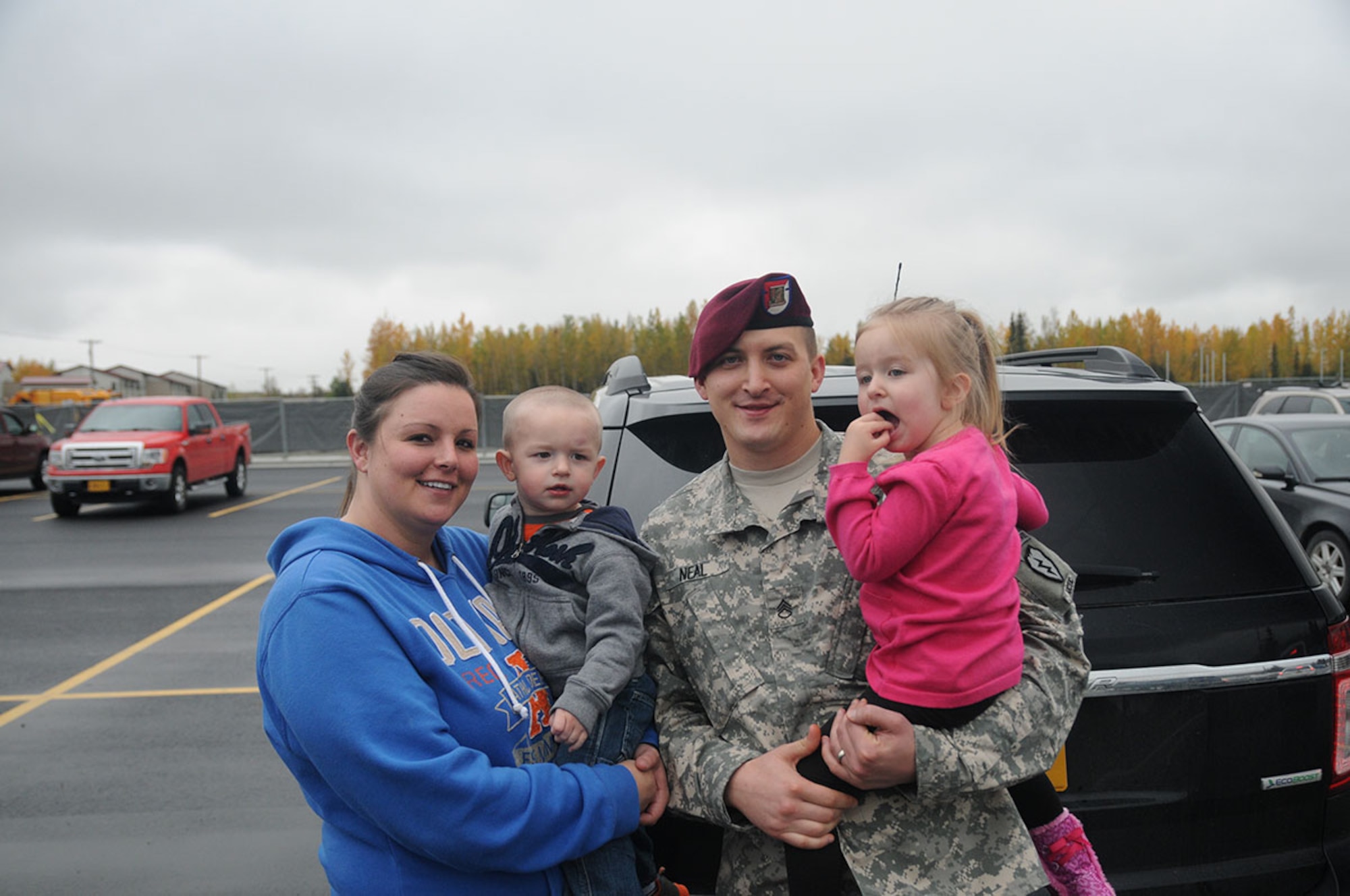 Staff Sgt. Gerald Neal, an intelligence analyst with the 1st Squadron (Airborne), 40th Cavalry Regiment, 4th Infantry Brigade Combat Team (Airborne), 25th Infantry Division, takes a moment for a photo with his Family following the Danali Squadron’s deployment ceremony September 19, 2014 at Joint Base Elmendorf-Richardson, Alaska. (U.S. Army photo/Sgt. Brian Ragin)