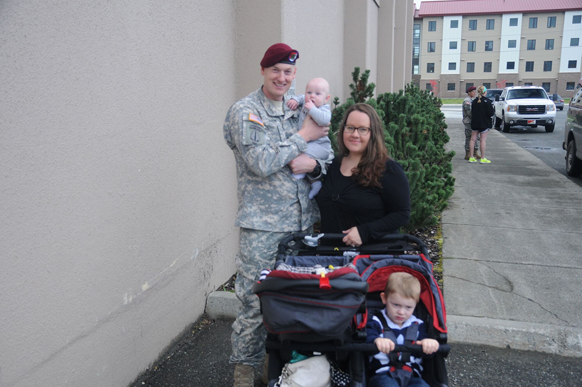 A paratrooper with the 1st Squadron (Airborne), 40th Cavalry Regiment, 4th Infantry Brigade Combat Team (Airborne), 25th Infantry Division takes a moment for a photo with his Family following the Danali Squadron’s deployment ceremony Sept. 19, 2014 at Joint Base Elmendorf-Richardson, Alaska. (U.S. Army photo/Sgt. Brian Ragin)