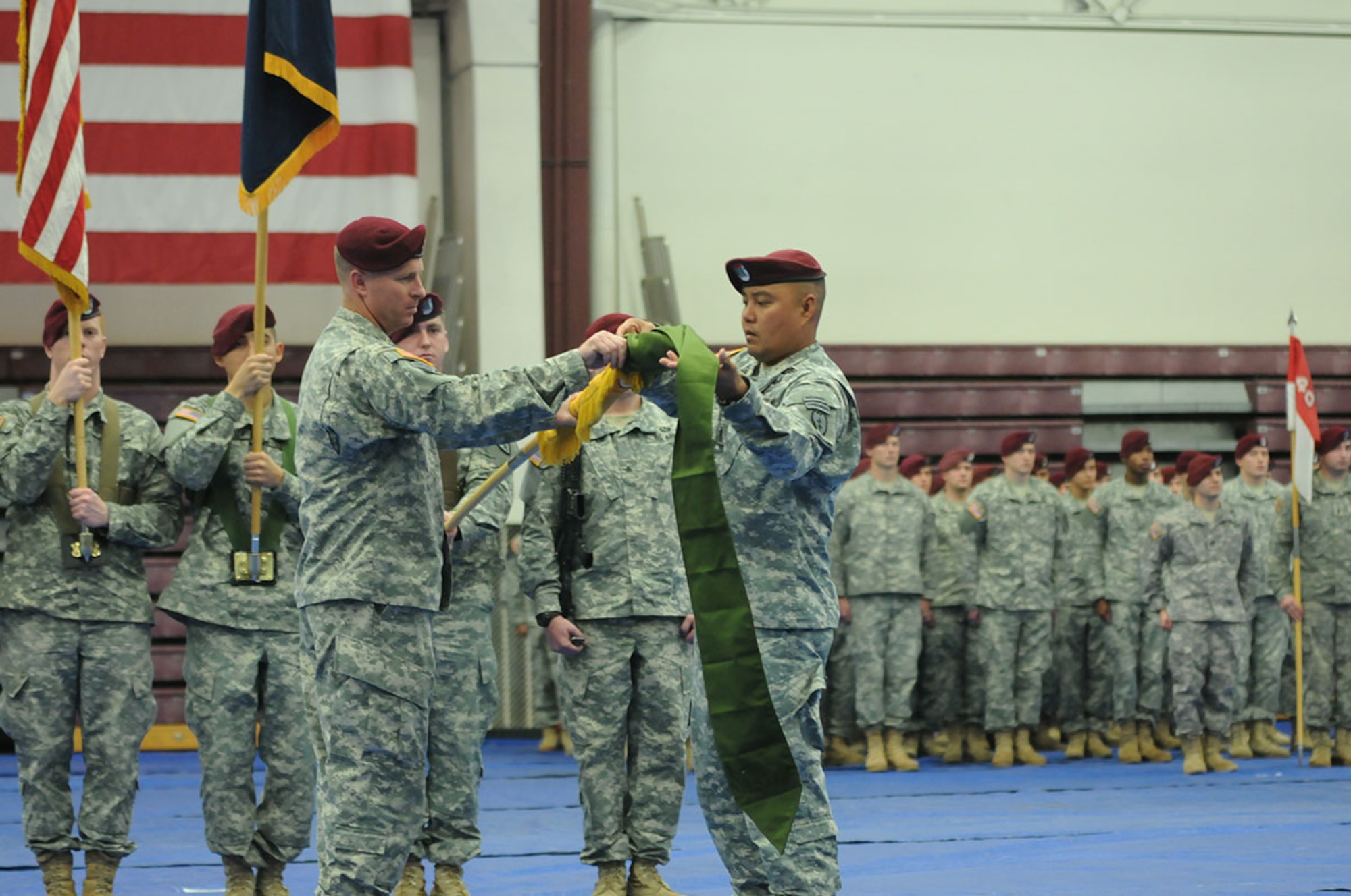 Lt. Col.  Mark D. Federovich (left), the commander of the 1st Squadron (Airborne), 40th Cavalry Regiment, 4th Infantry Brigade Combat Team (Airborne), 25th Infantry Division, and Command Sgt. Maj. Jan C. Araneta (right), the senior enlisted advisor of Denali Squadron, case the unit’s colors during the squadron’s deployment ceremony September 19, 2014 at Joint Base Elmendorf-Richardson, Alaska. (U.S. Army photo/Sgt. 1st Class Jeffrey Smith)