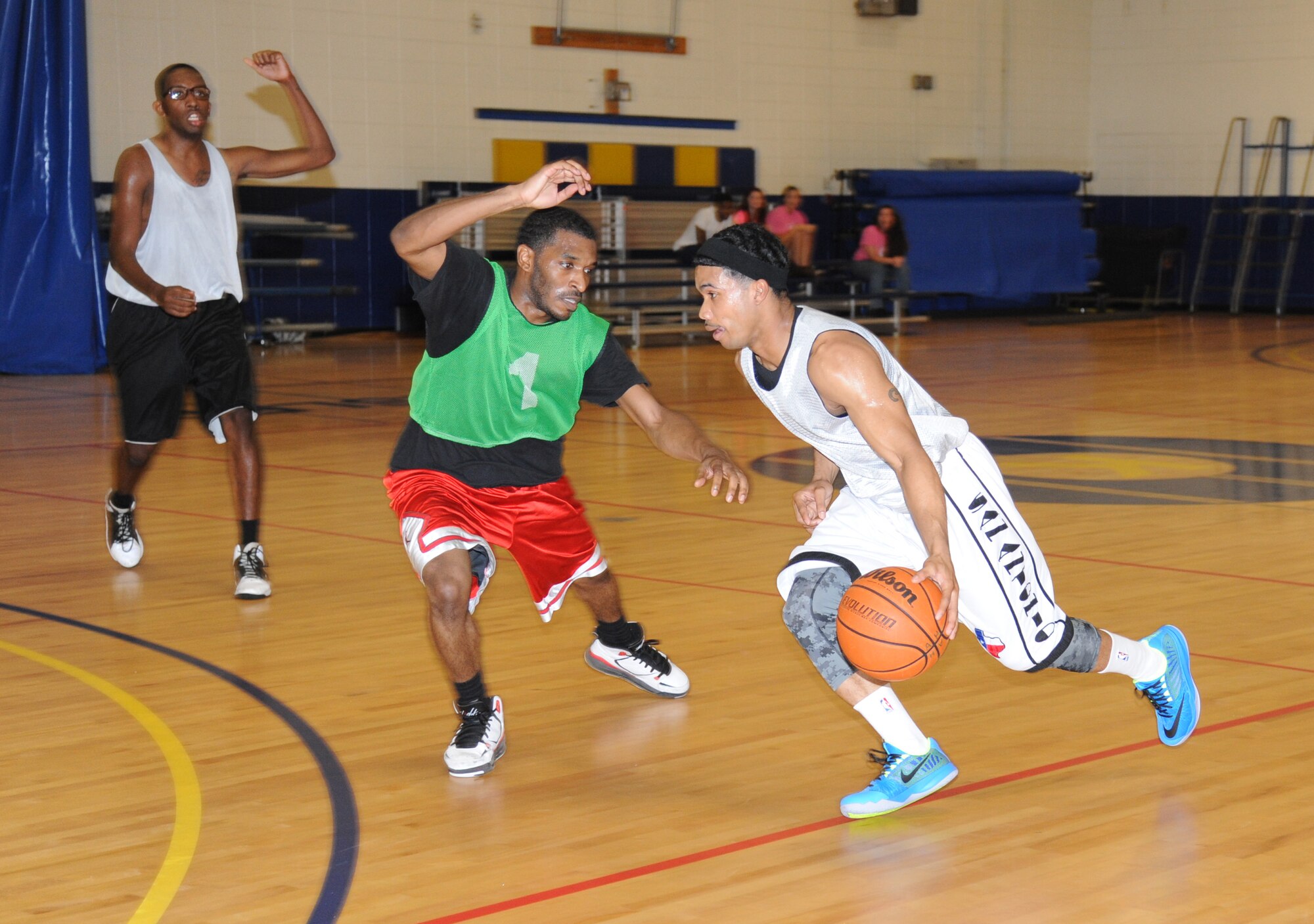 Dominic Anderson, 81st Diagnostic and Therapeutics Squadron, defends Mario McKnight, 81st Medical Group, as he drives the ball towards the basket during the intramural basketball championship game Sept. 25, 2014, at the Blake Fitness Center, Keesler Air Force Base, Miss.  The 81st MDG defeated the 81st MDTS, 41-37.  (U.S. Air Force photo by Kemberly Groue)