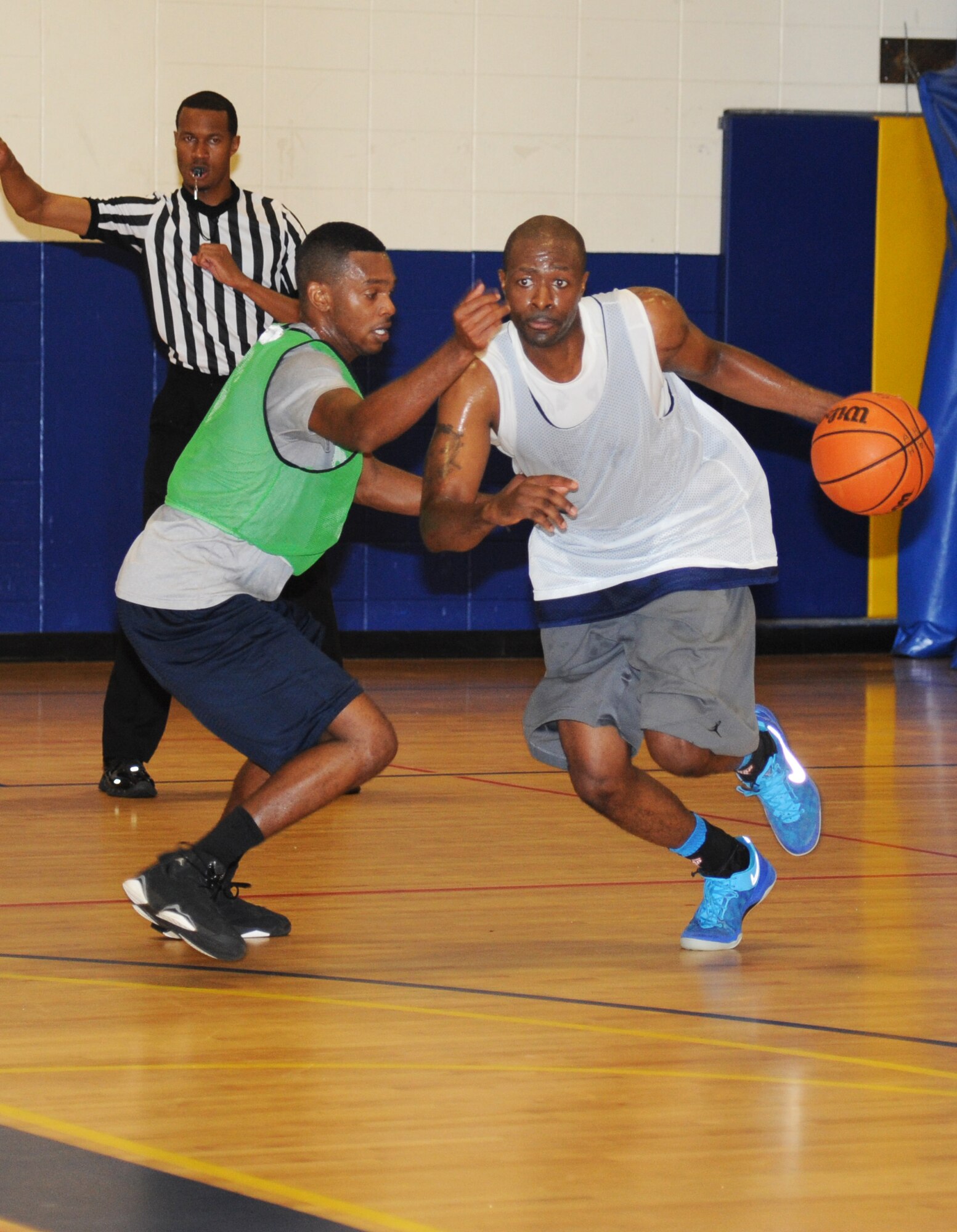 Gregory Jernigan, 81st Diagnostic and Therapeutics Squadron, defends against Alvin Holmes, 81st Medical Group, during the intramural basketball championship game Sept. 25, 2014, at the Blake Fitness Center, Keesler Air Force Base, Miss.  The 81st MDG defeated the 81st MDTS, 41-37.  (U.S. Air Force photo by Kemberly Groue)