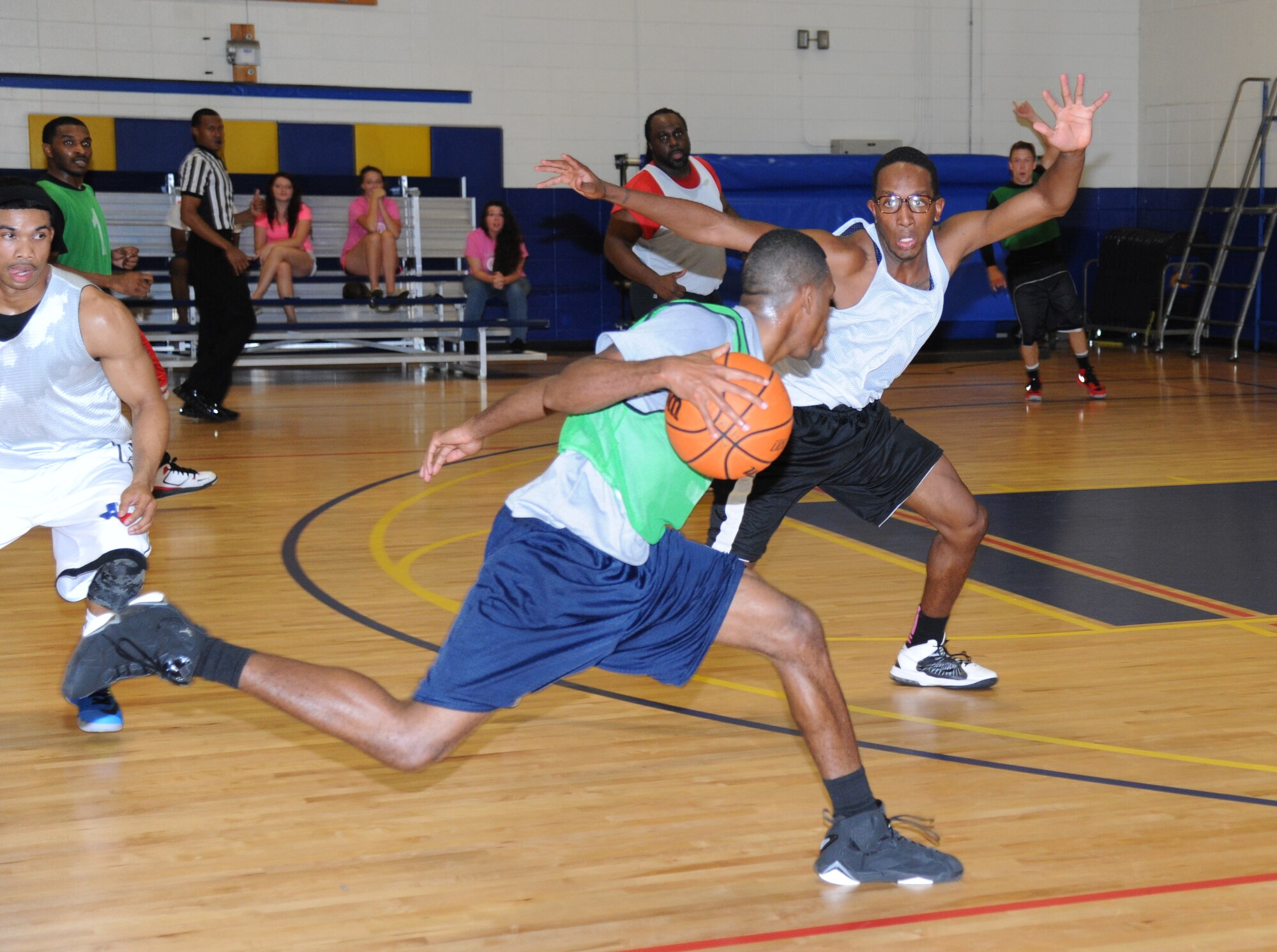 Gregory Jernigan, 81st Diagnostic and Therapeutics Squadron, drives the ball towards the basket as Marquez Barr, 81st Medical Group protects the inside during the intramural basketball championship game Sept. 25, 2014, at the Blake Fitness Center, Keesler Air Force Base, Miss.  The 81st MDG defeated the 81st MDTS, 41-37.  (U.S. Air Force photo by Kemberly Groue)