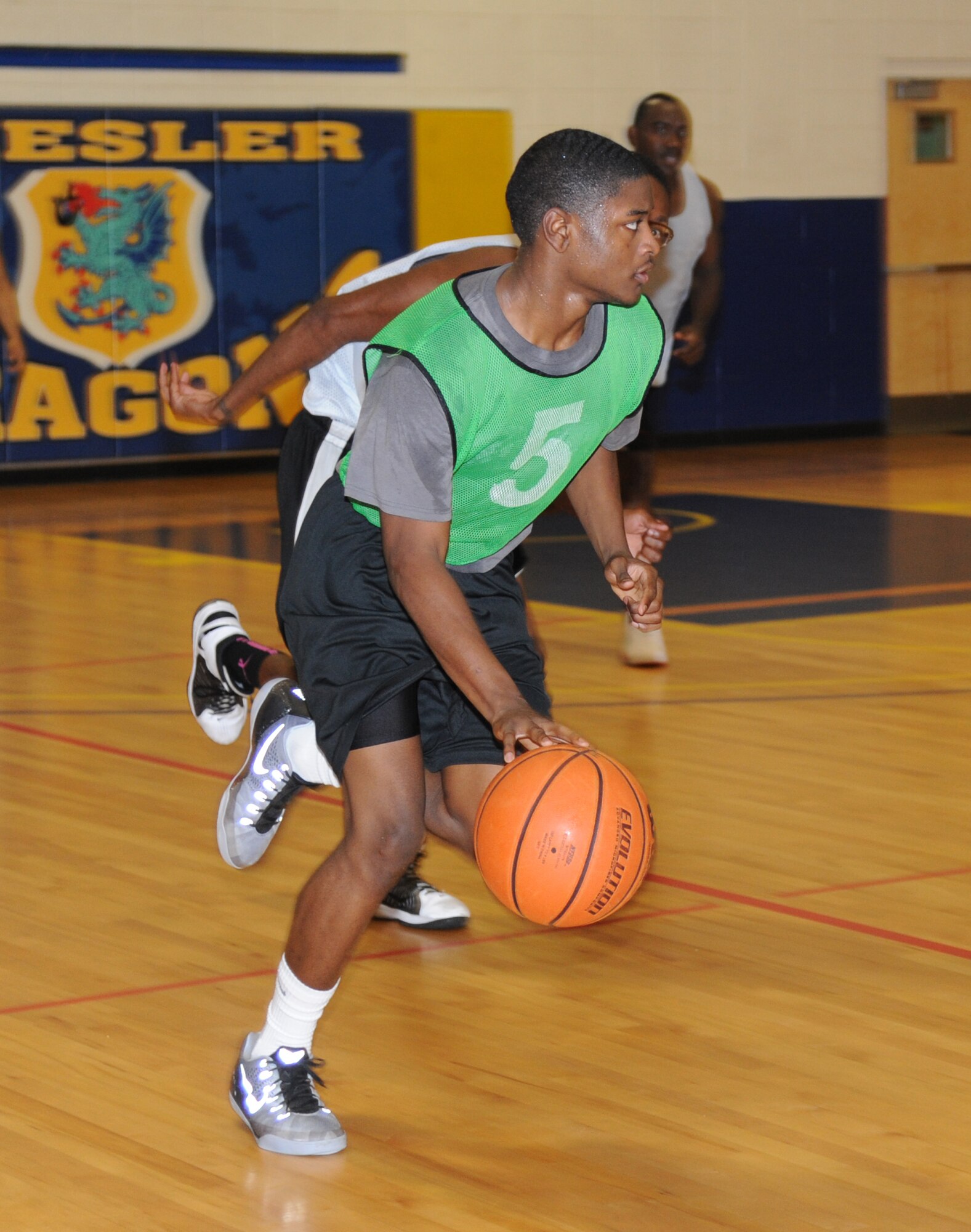 Brandon McCullum, 81st Diagnostic and Therapeutics Squadron, dribbles the ball downcourt during the intramural basketball championship game Sept. 25, 2014, at the Blake Fitness Center, Keesler Air Force Base, Miss.  The 81st Medical Group defeated the 81st MDTS, 41-37.  (U.S. Air Force photo by Kemberly Groue)