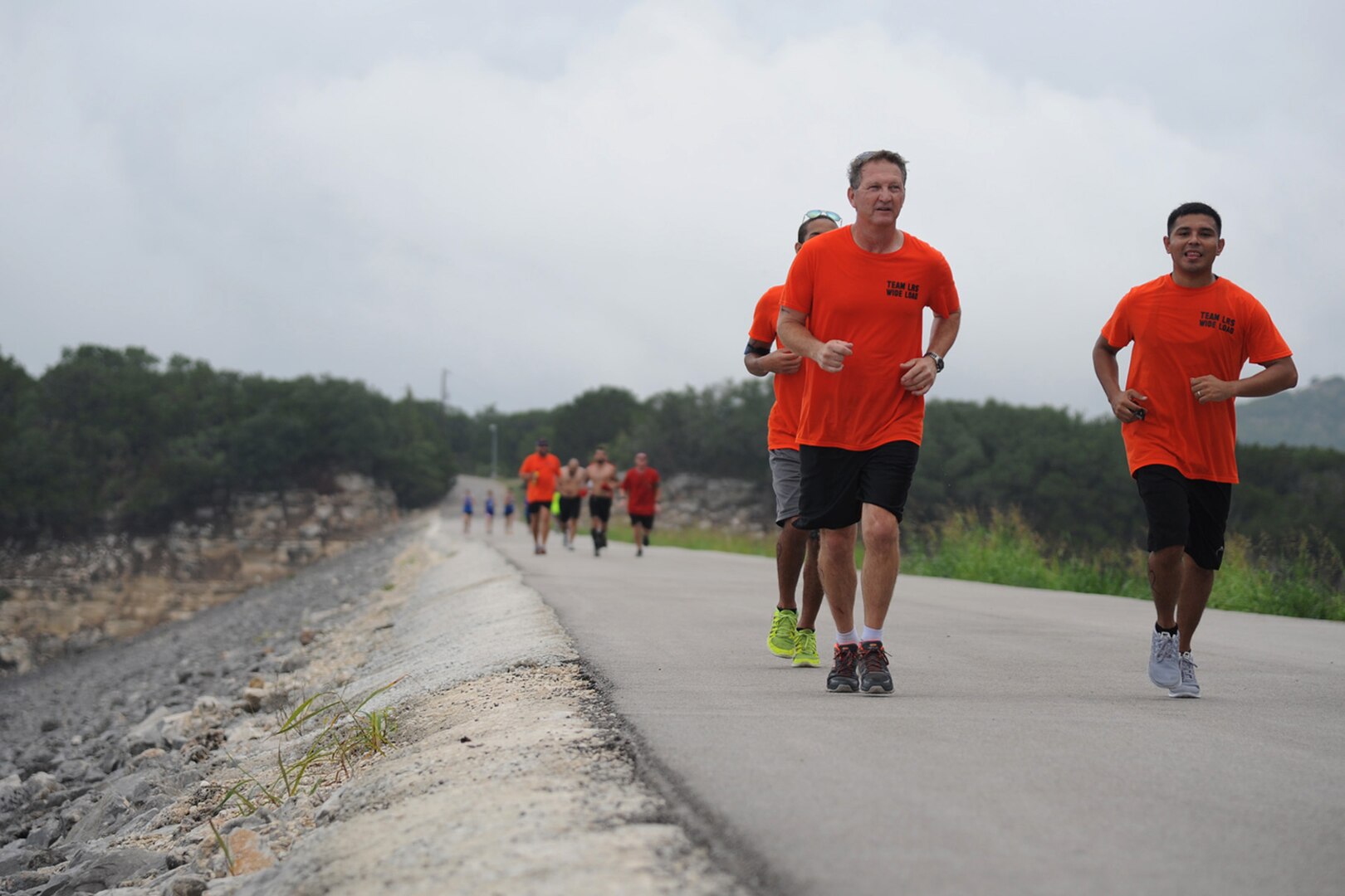 Teams run to one end of a .8 mile dam and back as part of the 6-mile run portion of the Rambler 120 Sept. 20 at Canyon Lake, Texas. In addition to the run, there was a 22-mile bike ride and 2-mile boat race. (U.S. Air Force photo by Senior Airman Krystal Jeffers/Released)