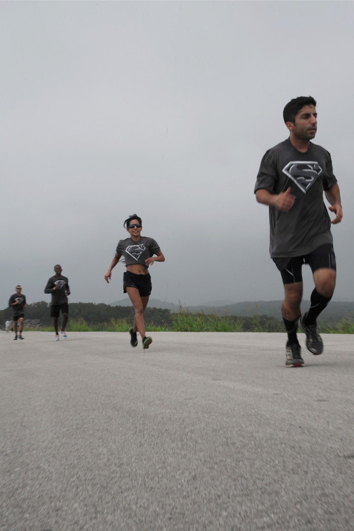 A four man team races across a dam Sept. 20 as part of the Rambler 120 at Canyon Lake, Texas. The race was composed of three parts: a 22-mile bike ride, 6-mile run and a 2-mile boat race.  (U.S. Air Force photo by Senior Airman Krystal Jeffers/Released)