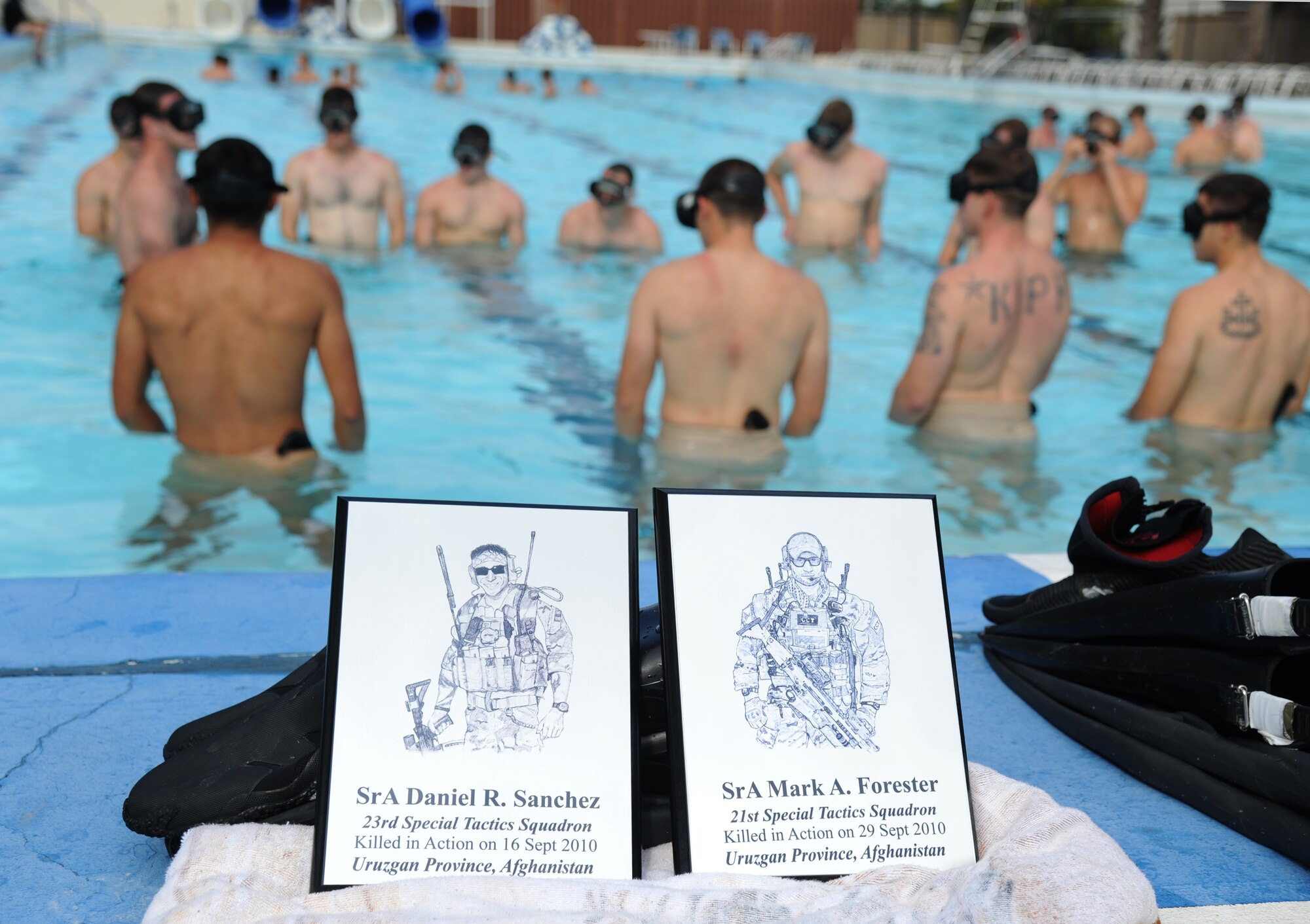 Members of the 334th Training Squadron combat controllers and the 335th Training Squadron special operations weather team participate in a memorial physical training session Sept. 26, 2014, at the triangle pool, Keesler Air Force Base, Miss.  The session began with a ruck march along the Ocean Springs Beach and over the Biloxi/Ocean Springs Bridge. The PT event was in memory of combat controller Senior Airman Mark Forester who was killed in action Sept. 29, 2010, and Senior Airman Daniel Sanchez who was killed in action Sept. 16, 2010.  (U.S. Air Force photo by Kemberly Groue)