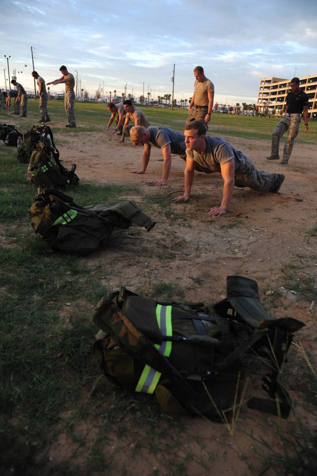 Members of the 334th Training Squadron combat controllers and the 335th Training Squadron special operations weather team participate in a memorial physical training session Sept. 26, 2014, Biloxi, Miss., with burpees and a ruck march along the Ocean Springs Beach and over the Biloxi/Ocean Springs Bridge. The PT event was in memory of combat controller Senior Airman Mark Forester who was killed in action Sept. 29, 2010, and Senior Airman Daniel Sanchez who was killed in action Sept. 16, 2010.  (U.S. Air Force photo by Kemberly Groue)