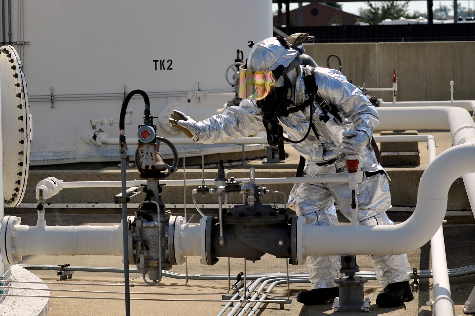 Tobias Midkiff, 375th Civil Engineering Squadron station chief, shuts off a broken valve at the 126th Air National Guard’s fuel tanks at Scott Air Force Base, Ill., Sept. 25, 2014. The 375th Air Mobility Wing Inspection Team observed the exercise, to ensure the most efficient approaches were taken to resolve the problem. The firefighters analyzed the problem, and practiced what they would do in a real life emergency. (U.S. Air Force photo by Airman 1st Class Erica Crossen)