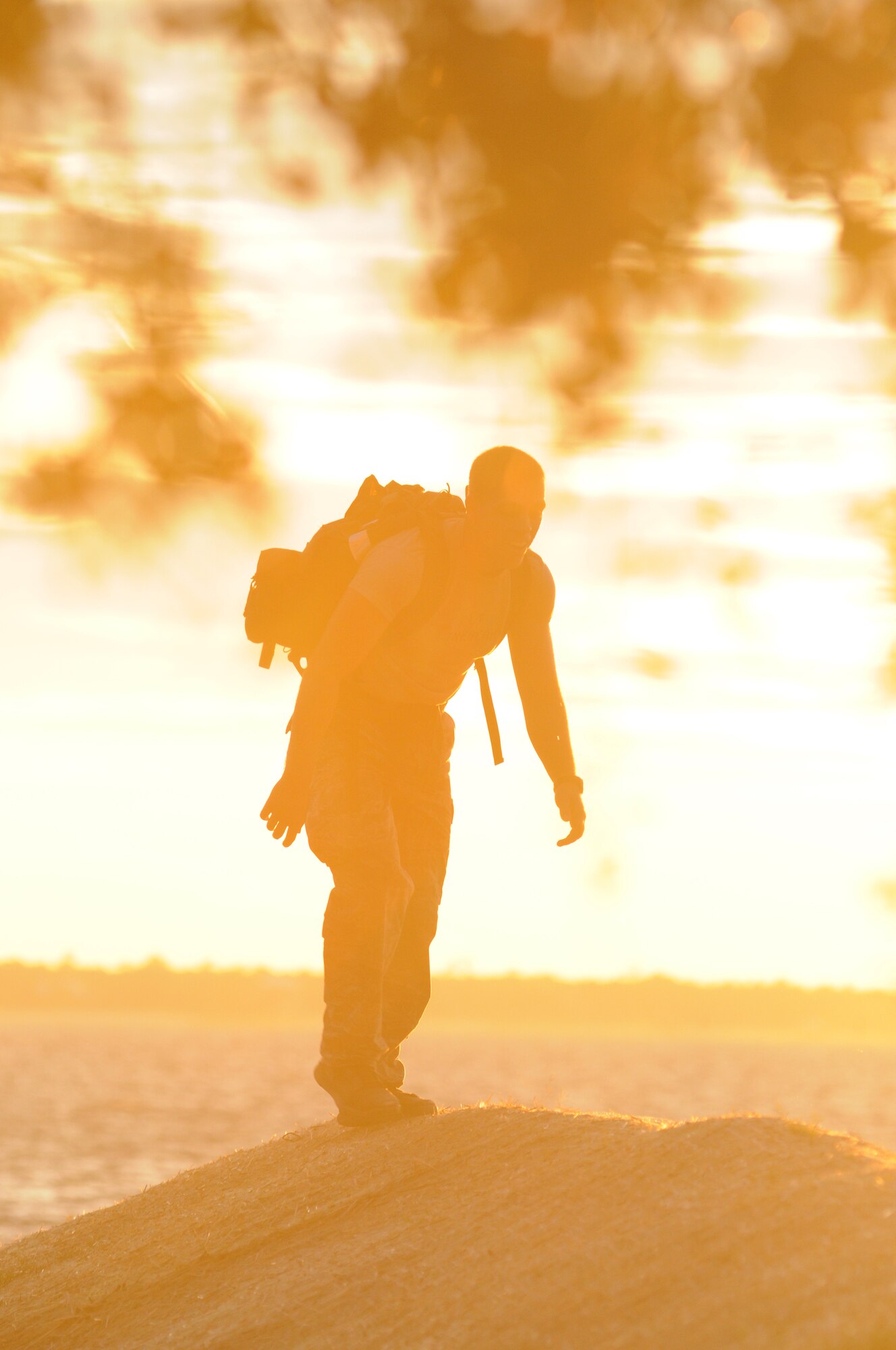 A Keesler battlefield Airman arrives at the foot of the Biloxi/Ocean Springs Bridge as he participates in a memorial physical training session with other Keesler battlefield Airmen Sept. 26, 2014, Biloxi, Miss., with a ruck march along the Ocean Springs Beach and over the Biloxi/Ocean Springs Bridge. The PT event was in memory of combat controller Senior Airman Mark Forester who was killed in action Sept. 29, 2010, and Senior Airman Daniel Sanchez who was killed in action Sept. 16, 2010.  (U.S. Air Force photo by Kemberly Groue)