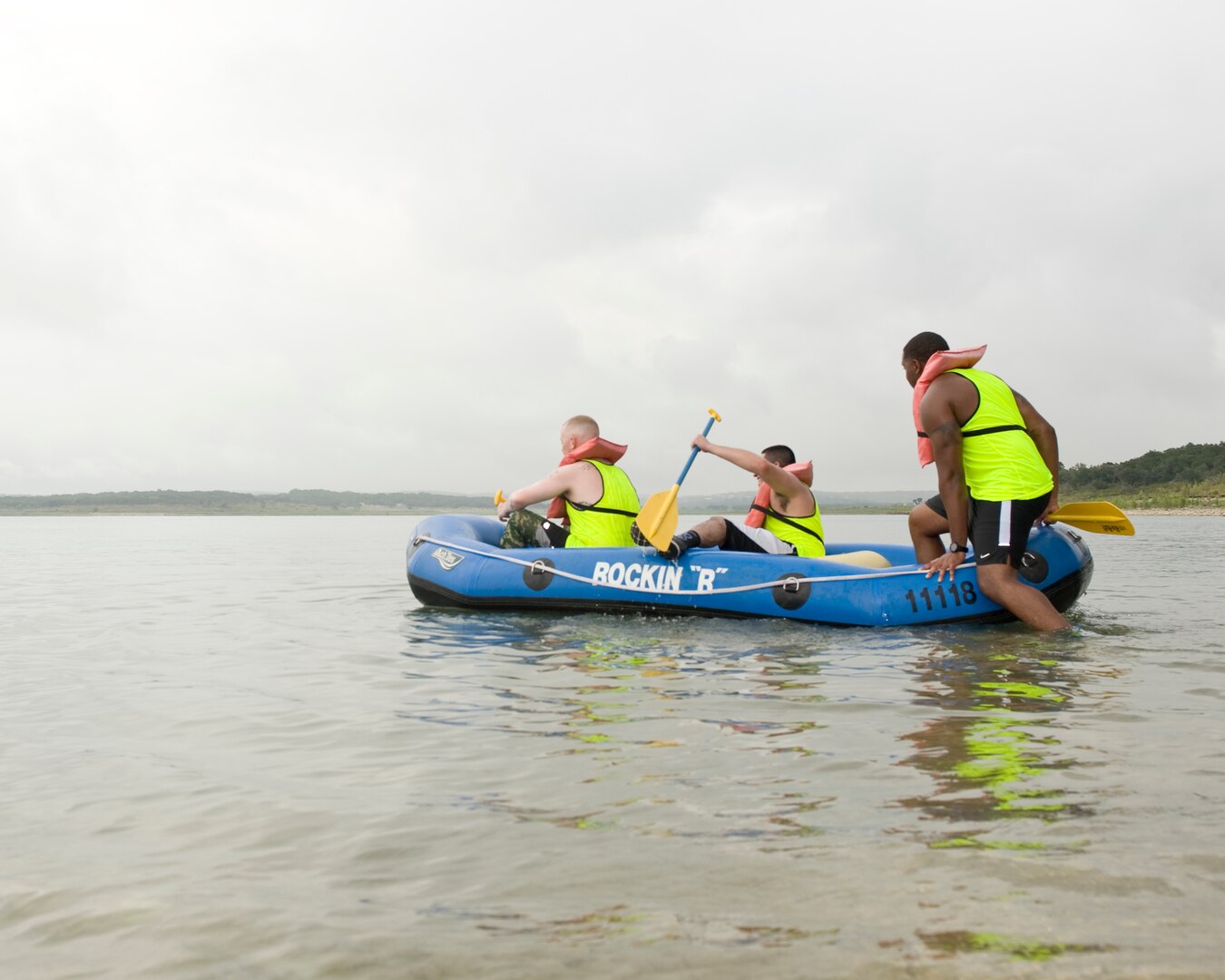 At the Rambler 120 Adventure Race at Joint Base San Antonio Recreation Park, Sept. 20, 2014, teammates come together to finish the final of three strenuous legs of the race. The overcast weather at Canyon Lake provided some relief for the relay teams during the final two-mile rafting portion. (U.S. Air Force photo by Airman Justine K. Rho/released) 