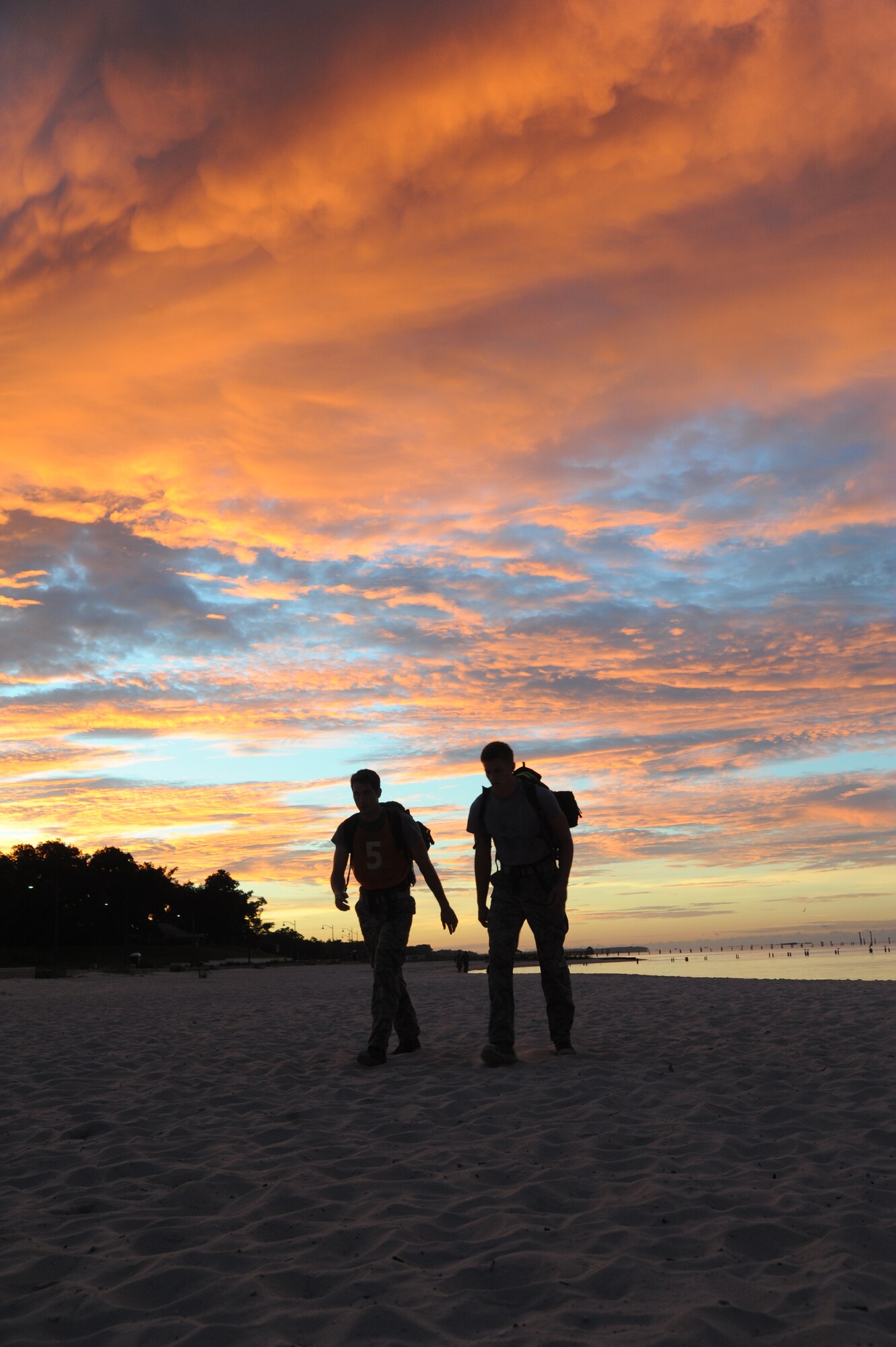 Members of the 334th Training Squadron combat controllers and the 335th Training Squadron special operations weather team participate in a memorial physical training session Sept. 26, 2014, Ocean Springs, Miss., with a ruck march along the Ocean Springs Beach and over the Biloxi/Ocean Springs Bridge. The PT event was in memory of combat controller Senior Airman Mark Forester who was killed in action on Sept. 29, 2010, and Senior Airman Daniel Sanchez who was killed in action Sept. 16, 2010.  (U.S. Air Force photo by Kemberly Groue)