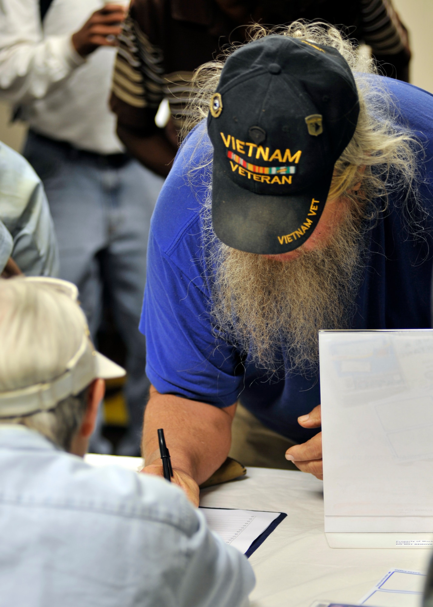 A Vietnam hero signs in to be escorted by an active-duty service member Sept. 25 at First Baptist Church in Panama City, Fla. CareerSource Gulf Coast hosted the 7th Annual Homeless Veteran Stand Down event where veterans receive free haircuts, medical aid and hot lunches. (U.S. Air Force photo by Airman 1st Class Sergio A. Gamboa)