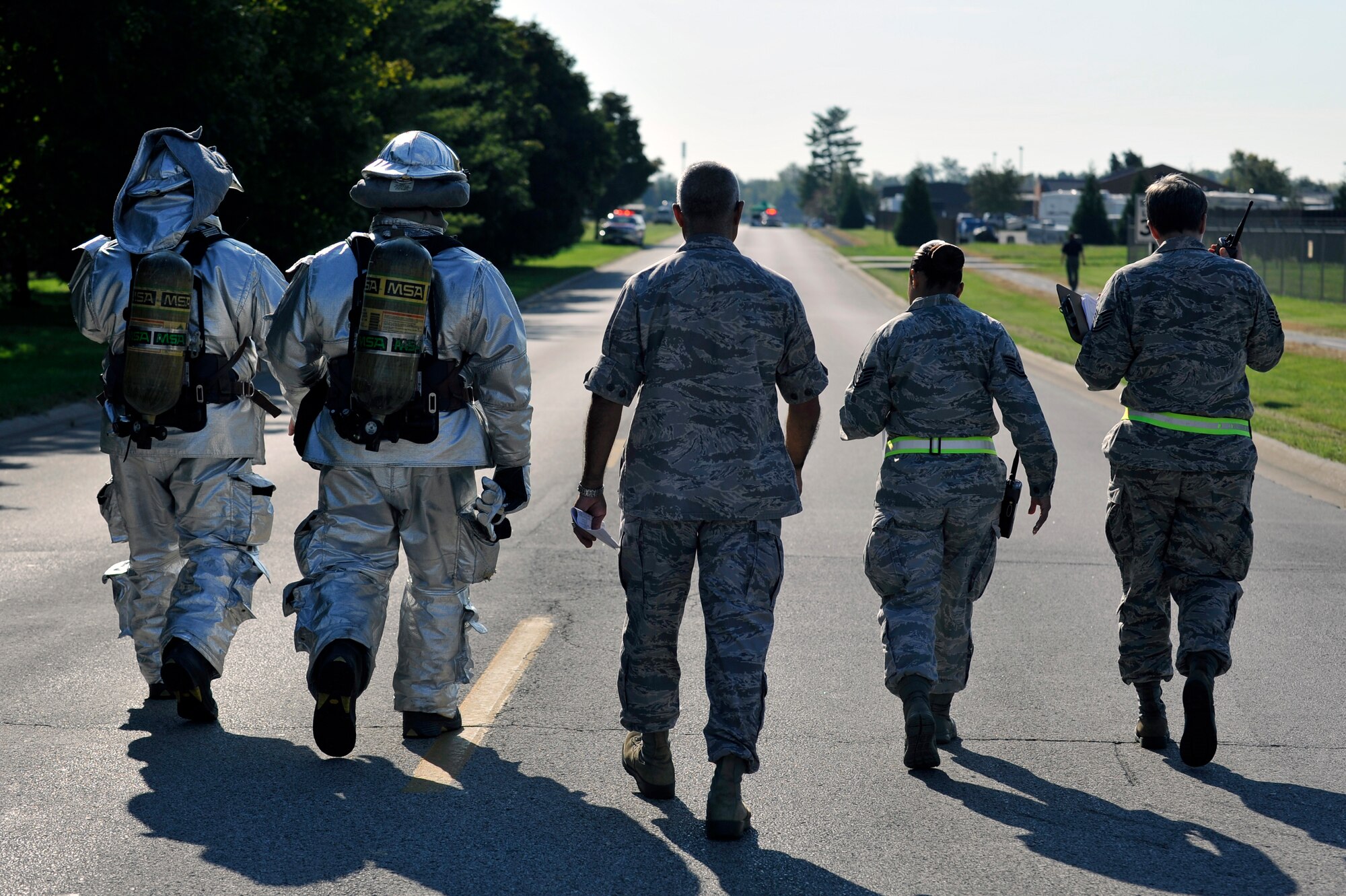 375th Civil Engineering Squadron firefighters work through a simulated fuel spill strategy while the 375th Air Mobility Wing Inspection Team observes at Scott Air Force Base, Ill., Sept. 25, 2014. The 126th Air National Guard’s fuel tanks had a simulated leaking valve. Under a ticking clock, 375 CES, bioenvironmental, security forces, and other base resources converged to quickly mitigate the problem. The Wing Inspection Team observed the actions of the participating players and suggested the players went through the scenario just as they would do in real life to get the most out of the exercise. (U.S. Air Force photo by Airman 1st Class Erica Crossen)