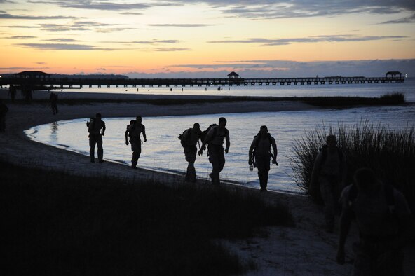 Members of the 334th Training Squadron combat controllers and the 335th Training Squadron special operations weather team participate in a memorial physical training session Sept. 26, 2014, Ocean Springs, Miss., with a ruck march along the Ocean Springs Beach and over the Biloxi/Ocean Springs Bridge. The PT event was in memory of combat controller Senior Airman Mark Forester who was killed in action on Sept. 29, 2010, and Senior Airman Daniel Sanchez who was killed in action Sept. 16, 2010.  (U.S. Air Force photo by Kemberly Groue)