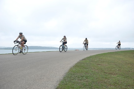 Four-member relay teams power through the 22-mile bike route Sept. 20, 2014 at the Rambler 120 Adventure Race at Joint Base San Antonio Recreation Park on Canyon Lake. Throughout the race, the first and last team member must stay within 50 yards of each other to avoid penalties. A six-mile run and two-mile raft race follow the 22-mile bike race. (U.S. Air Force photo by Airman Justine K. Rho/released)