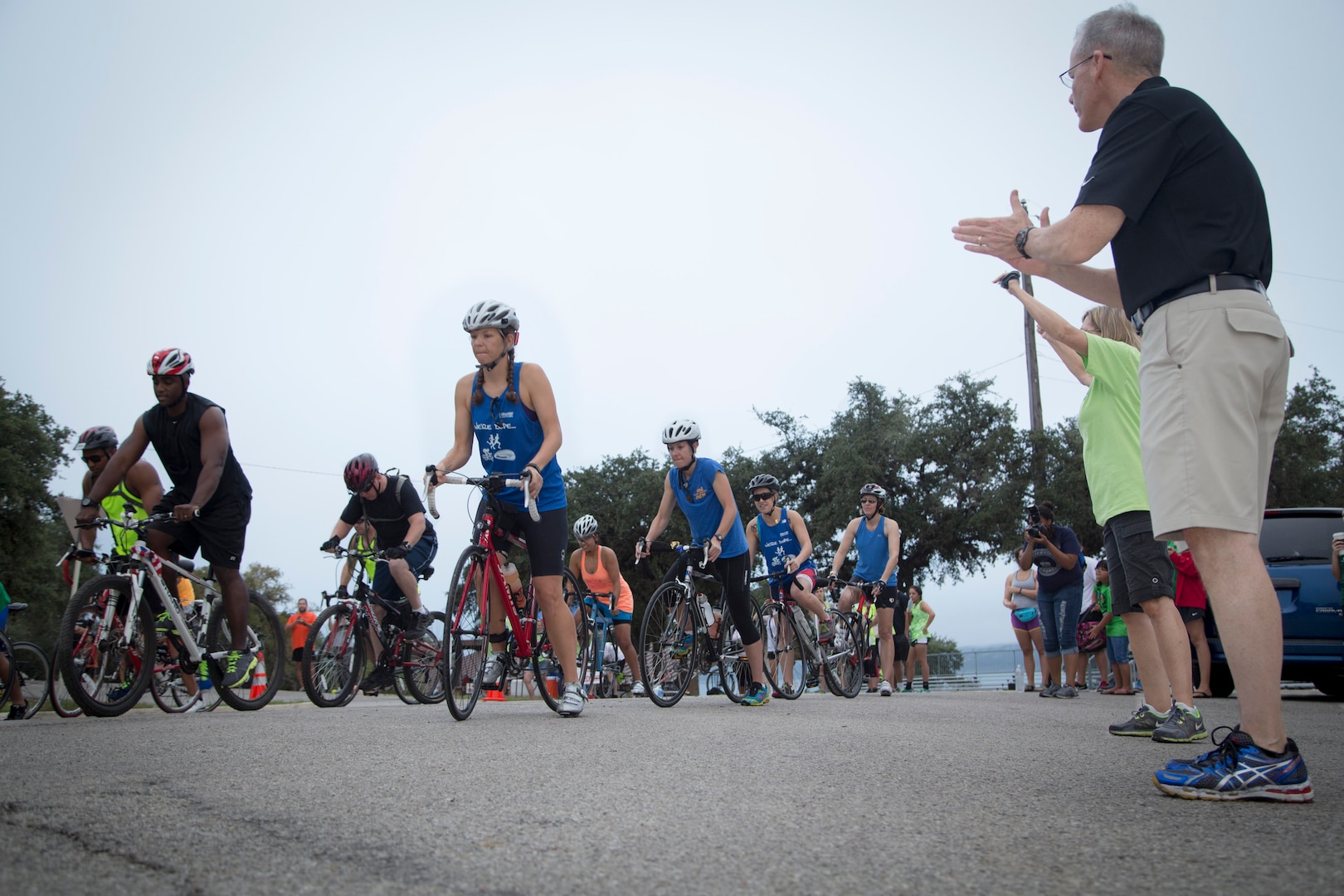 Brig. Gen. Bob LaBrutta 502 Air Base Wing and Joint Base San Antonio Commander cheers on participants at the start of the Rambler 120 Race, which includes running, biking, rafting and a mystery event, was held at Joint Base San Antonio Recreation Park at Canyon Lake Sept. 20.  Twenty-nine teams competed in the 22-mile bike course, 6-mile run 2-mile rafting event and the frisbee golf challenge. (U.S. Air Force photo by Joshua Rodriguez) (released)