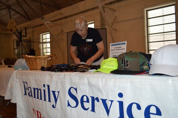 Pauline Chaffee with the Bay County Family Services Agency sorts through sunglasses to be given to homeless veterans attending the annual Homeless Veterans Stand Down Sept. 25 at the Family Life Center of First Baptist Church in Panama City. Approximately 120 veterans attended the event which included hot meals, medical services, Veterans Affairs and housing assistance. (Photo by Mary McHale)
