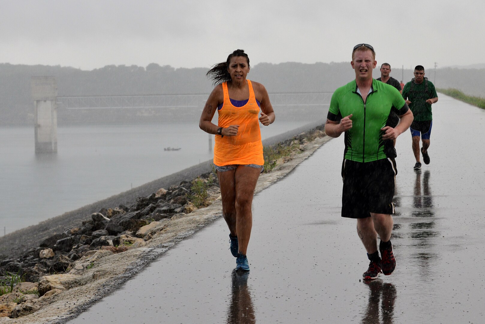 Staff Sgt. Antonieta  Jara, front left, and Staff Sgt. Joshua Gaffney, front right, Staff Sgt. Grant Coultas, back left, and Staff Sgt. Vince Cantu, back right, run on top of the Canyon Lake dam Sept. 20 during the Rambler 120 Race. The Rambler 120 Race, which includes running, biking, rafting and a mystery event, was held at Joint Base San Antonio Recreation Park at Canyon Lake Sept. 20. Twenty-nine teams competed in the 22-mile bike course, 6-mile run, 2-mile rafting event and a Frisbee toss mystery event. All team members are in team Tiger Punch. (U.S. Air Force photo/Desiree N. Palacios)