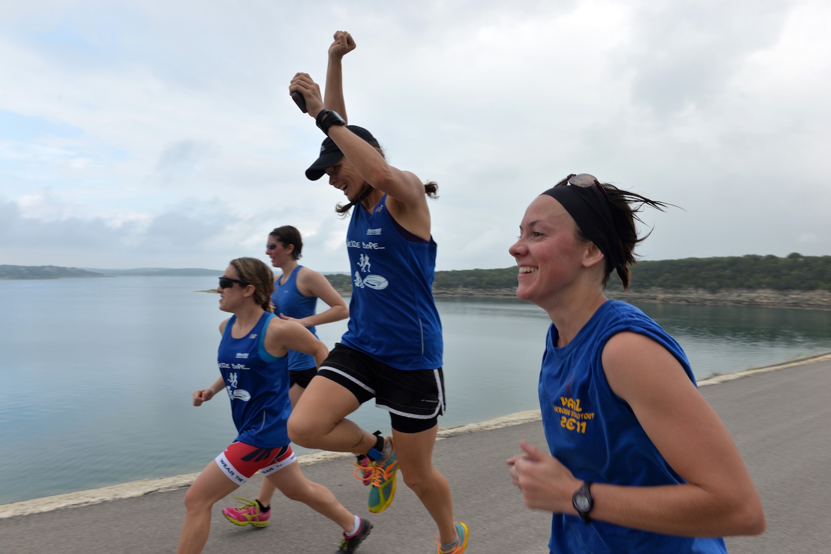 Master Sgt. Amy Morgan, from right to left, Capt. Brandy Caffee, Capt. Vincenza Grossman and Robyn Kadel runs on top of the Canyon Lake dam Sept. 20 during the Rambler 120 Race. The Rambler 120 Race, which includes running, biking, rafting and a mystery event, was held at Joint Base San Antonio Recreation Park at Canyon Lake Sept. 20. Twenty-nine teams competed in the 22-mile bike course, 6-mile run, 2-mile rafting event and a Frisbee toss mystery event.  All team members are in team DDR. (U.S. Air Force photo/Desiree N. Palacios)