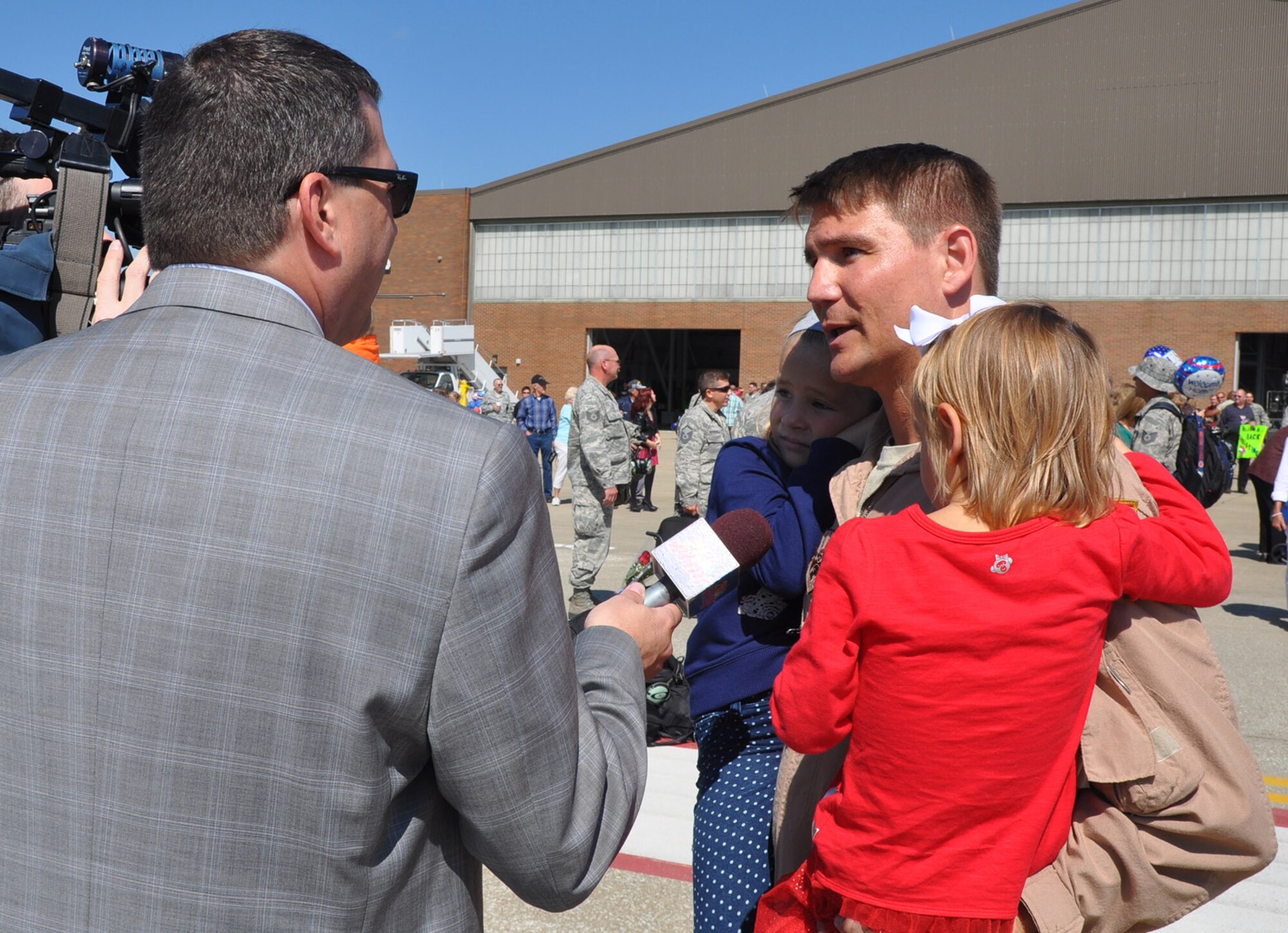 Air Force Reserve Lt. Col. John Boccieri, commander of the 757th Airlift Squadron and the 737th Expeditionary Squadron, talks about the recent deployment of more than 110 Citizen Airmen to Southwest Asia with a local television reporter here, Sept. 19, 2014. The 910th Airlift Wing Air Force Reservists returned from a 120-day deployment that provided tactical airlift in support of Operation Enduring Freedom. U. S. Air Force photo by Maj. Brent J. Davis