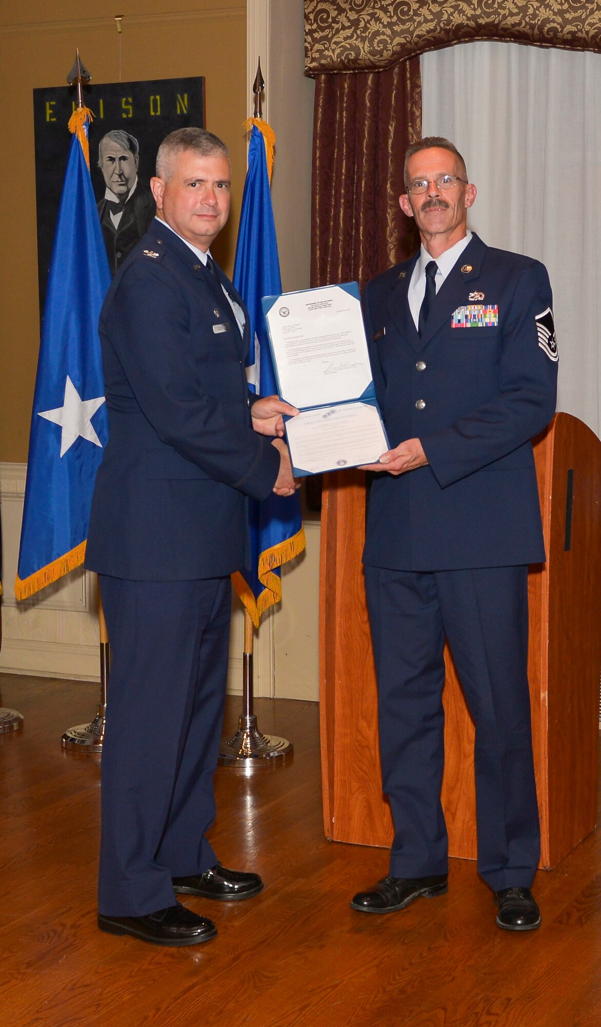 Col. Shawn Clouthier, 109th Airlift Wing commander, presents Master Sgt. Stephen Radz with the Certificate of Induction during a ceremony Sept. 25, 2014 at Schenectady County Community College, Schenectady, New York. The 109th AW Senior Noncommissioned Officer Induction Ceremony is an annual event held to recognize Airmen who were recently promoted to the rank of master sergeant. Radz is assigned to the 109th Maintenance Group at Stratton Air National Guard Base. (U.S. Air National Guard photo by Master Sgt. William Gizara/Released)