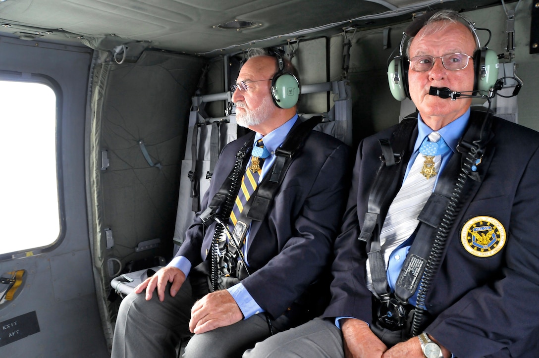 Congressional Medal of Honor recipients 1Lt Brian Thacker and Command Sergeant Maj. Robert Patterson take in the view of East Tennessee from an Army National Guard Blackhawk helicopter on their way to speak to students at Greenville High School while in Knoxville, Tennessee for the 2014 Medal of Honor Convention. (U.S. Air National Guard photo by Master Sgt. Kendra M. Owenby, 134 ARW Public Affairs)