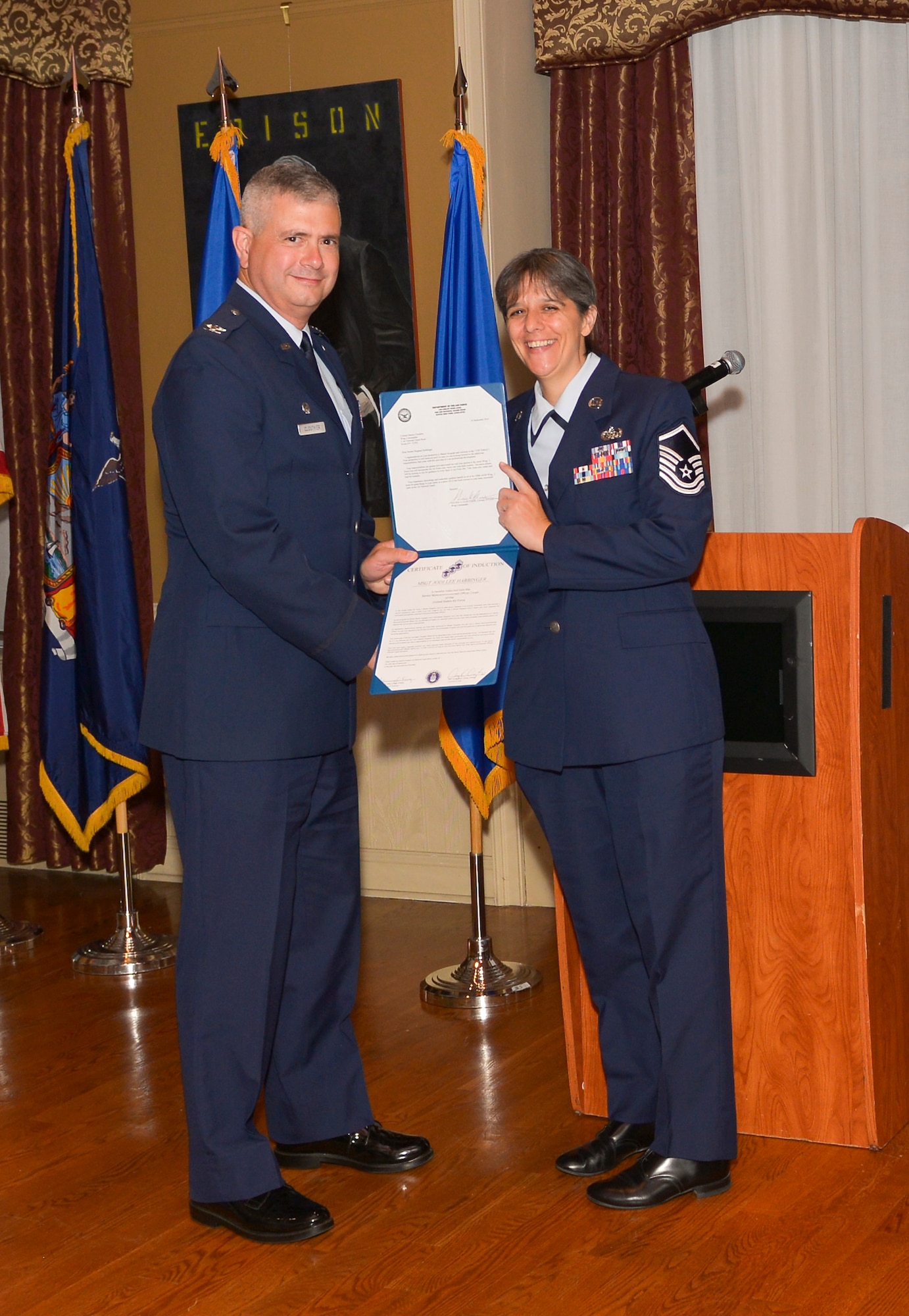 Col. Shawn Clouthier, 109th Airlift Wing commander, presents Master Sgt. Jodi Habbinger with the Certificate of Induction during a ceremony Sept. 25, 2014 at Schenectady County Community College, Schenectady, New York. The 109th AW Senior Noncommissioned Officer Induction Ceremony is an annual event held to recognize Airmen who were recently promoted to the rank of master sergeant. Habbinger is assigned to the 109th Communications Flight at Stratton Air National Guard Base. (U.S. Air National Guard photo by Master Sgt. William Gizara/Released)
