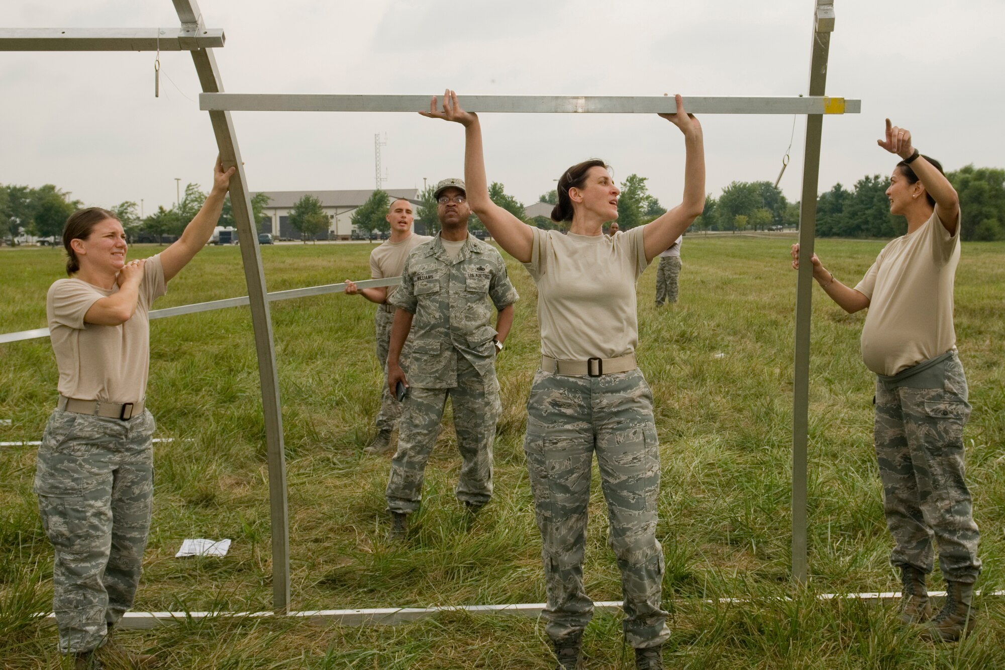 Brig. Gen. Curtis Williams, Air Force Reserve Command director of installations and mission support, observes students participating in a Junior Officer Leadership Development Course field training exercise as they attempt to assemble an extendable modular personnel tent building at Grissom Air Reserve Base, Ind. Aug. 16, 2014. The field training exercise is used to test the student's ability to integrate the leadership skills taught during the JOLD course with hands-on, teambuilding exercises similar to those that could be encountered during real-world scenarios. (U.S. Air Force photo/Staff Sgt. Ben Mota)  