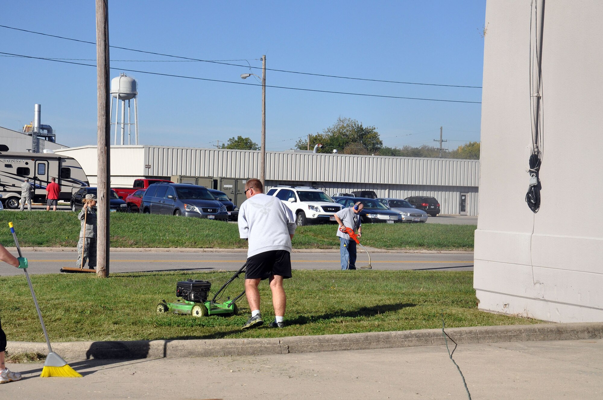 WRIGHT-PATTERSON AIR FORCE BASE, Ohio – Members of the 445th Aerospace Medicine Squadron mow and trim outside of Building 4012 during the 445th Airlift Wing Weed and Seed Morale Day Sept. 26, 2014. The event was held to beautify the surrounding area of the wing and enhance esprit de corps. Airmen from the wing picked up trash, weeded, mowed and trimmed around the various buildings. (U.S. Air Force photo/Stacy Vaughn)