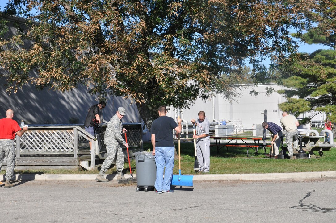 WRIGHT-PATTERSON AIR FORCE BASE, Ohio – Members of the 445th Maintenance Group sweep and rake leaves and debris around Building 4012 during the 445th Airlift Wing Weed and Seed Morale Day Sept. 26, 2014. The event was held to beautify the surrounding area of the wing and enhance esprit de corps. Airmen from the wing picked up trash, weeded, mowed and trimmed around the various buildings. The volunteers enjoyed doing something different and enjoyed working in teams to better their facilities and work areas (U.S. Air Force photo/Stacy Vaughn)