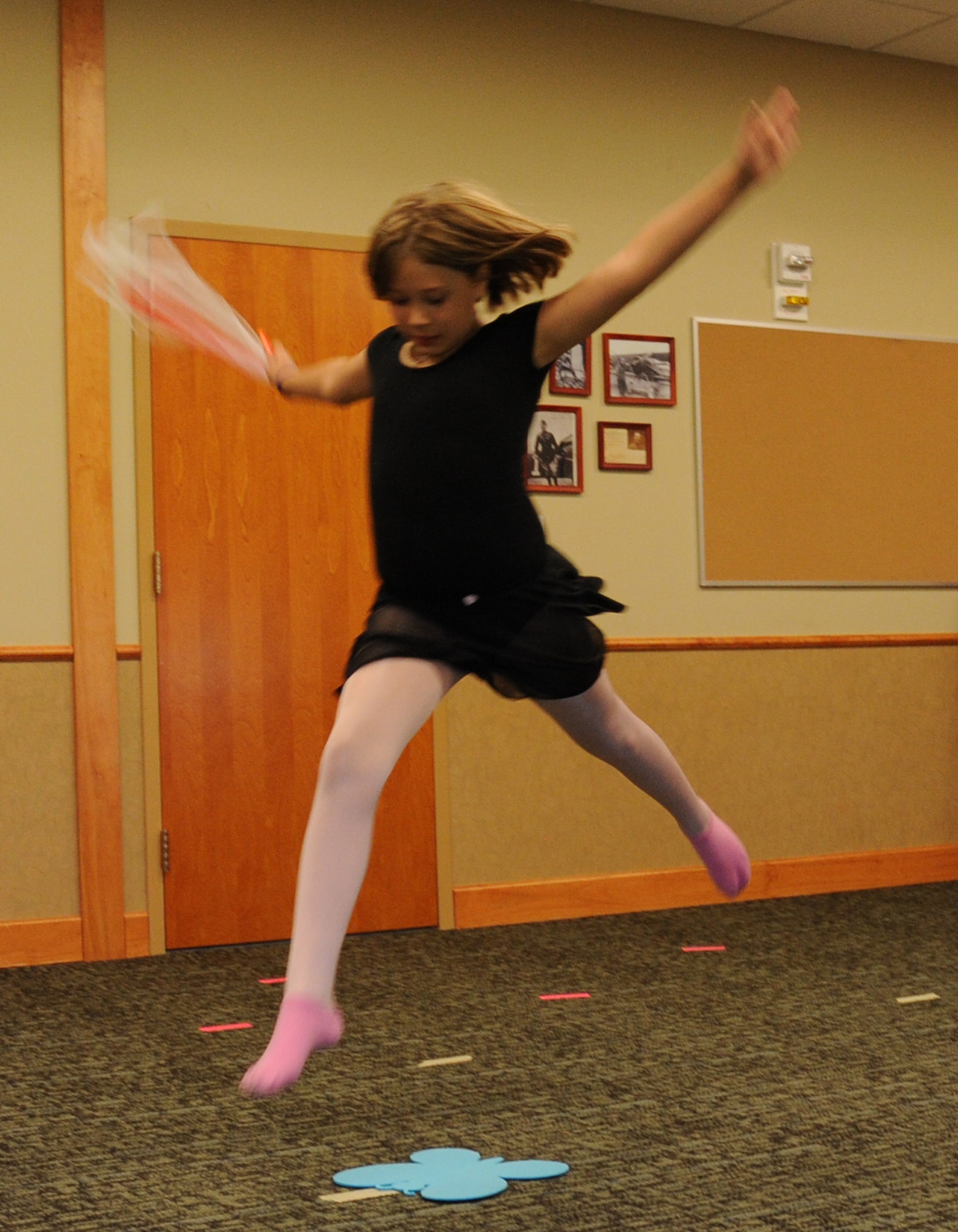 Aubrieghana Holmes leaps during a dance class taught at the Grizzly Bend at Malmstrom Air Force Base, Mont., Sept. 22.  Dance students were given this dance technique as homework, letting each child showcase their talent one at a time. (U.S. Air Force photo/Staff Sgt. Lindsey Soulsby)