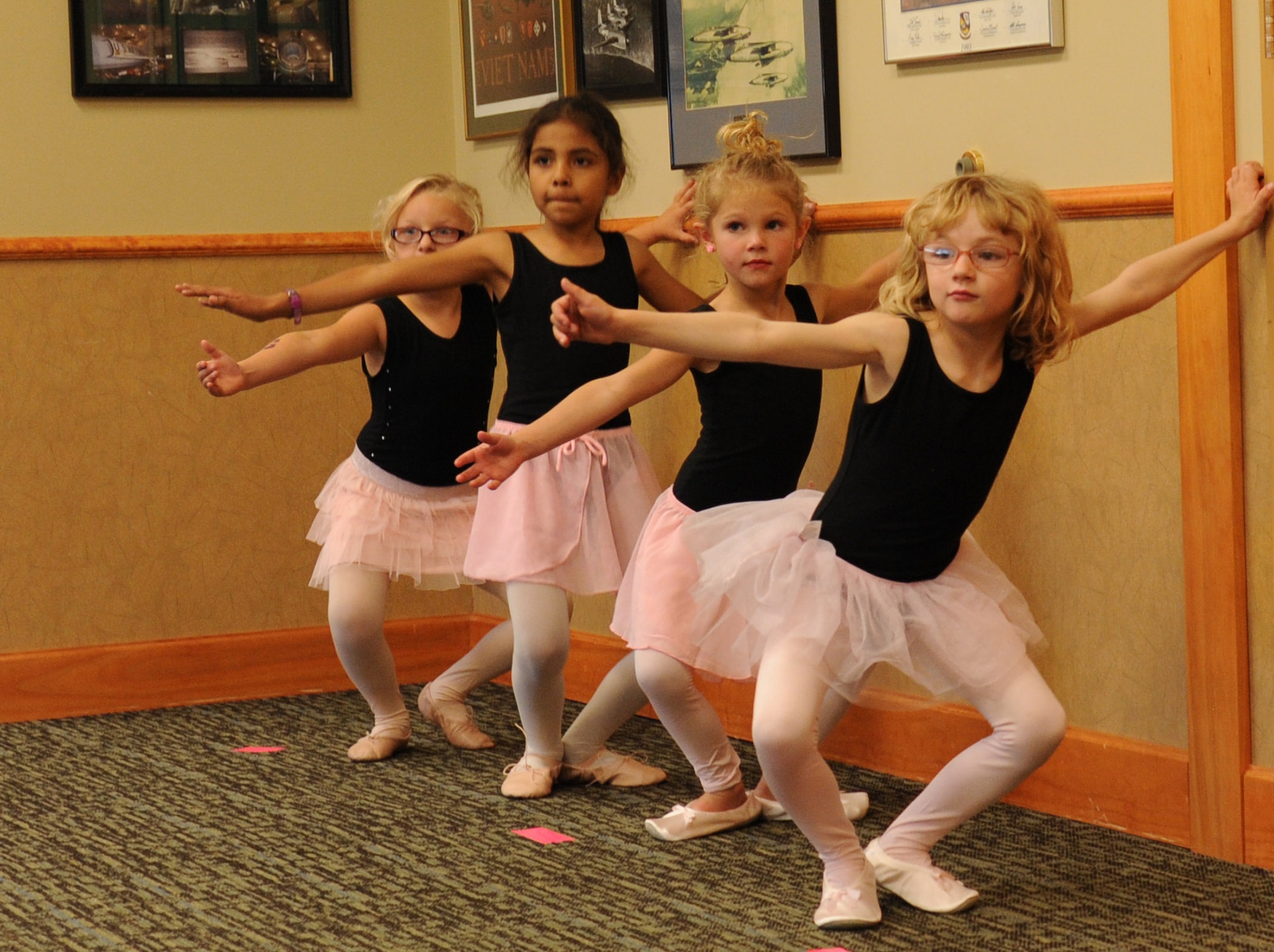 Beginning ballet students practice their pliés on Sept. 22 at the Grizzly Bend at Malmstrom Air Force Base, Mont.  The Bend offers five classes every Monday, including jazz, ballet and a mommy and me class.  (U.S. Air Force photo/Staff Sgt. Lindsey Soulsby)