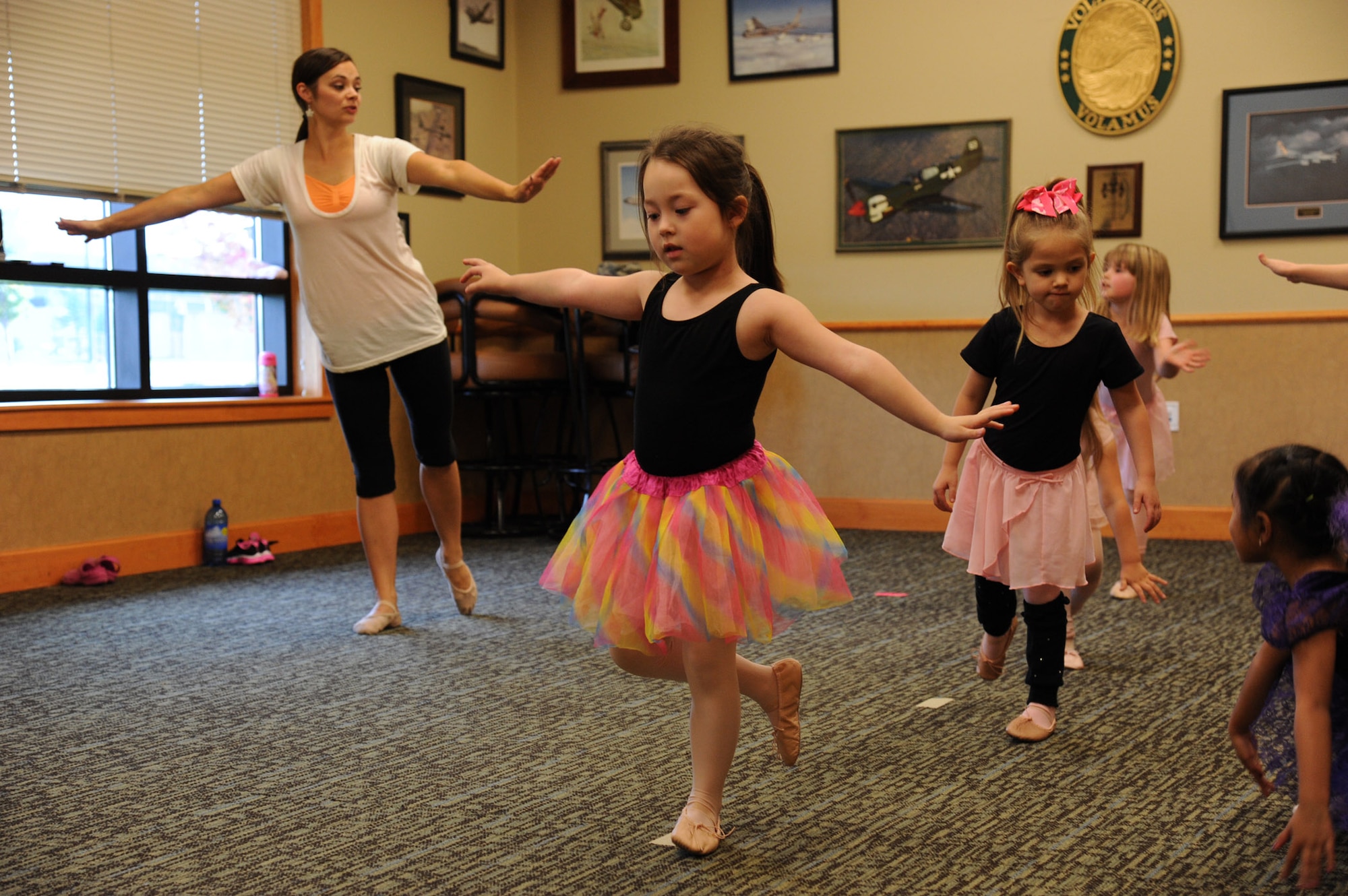 Beginning ballet students concentrate on lifting one leg at a time during class at the Grizzly Bend at Malmstrom Air Force Base, Mont., on Sept. 22.  Dance instructor Heather Dayton, will teach classes every week through December. (U.S. Air Force photo/Staff Sgt. Lindsey Soulsby) 