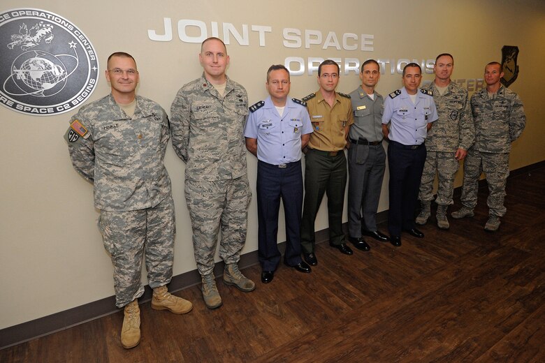 Members of Joint Force Component Command (JFCC) Space pose with members of the Brazilian Air Force during a visit to the Joint Space Operations Center (JSpOC) located at Vandenberg Air Force Base, Calif.,  Sep. 15, 2014.  The Brazilian Air Force officers met with numerous subject matter experts to obtain best practices as they work to establish their first military space operations center.  (U.S. Air Force photo by Michael Peterson/Released)