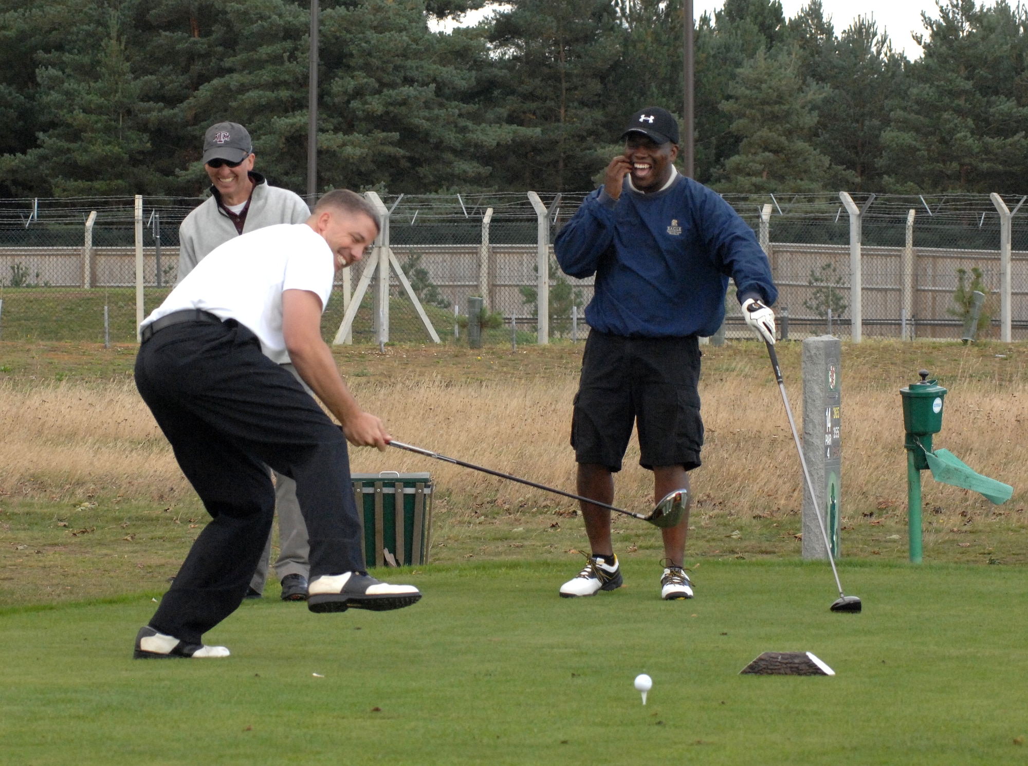 U.S. Air Force Senior Master Sgt. Sean Nelms, 100th Civil Engineer Squadron operations flight superintendent from Smithfield, Va., tries to keep upright after spinning around a golf club 10 times before hitting his drive on the 14th hole at the Chiefs vs. Eagles Golf Tournament Sept. 24, 2014 at the Breckland Pines Golf Club on RAF Lakenheath, England. The tournament was held in support of the Combined Federal Campaign and provided an opportunity to build partnerships and encourage morale across Team Mildenhall. (U.S. Air Force photo/Gary Rogers/Released)