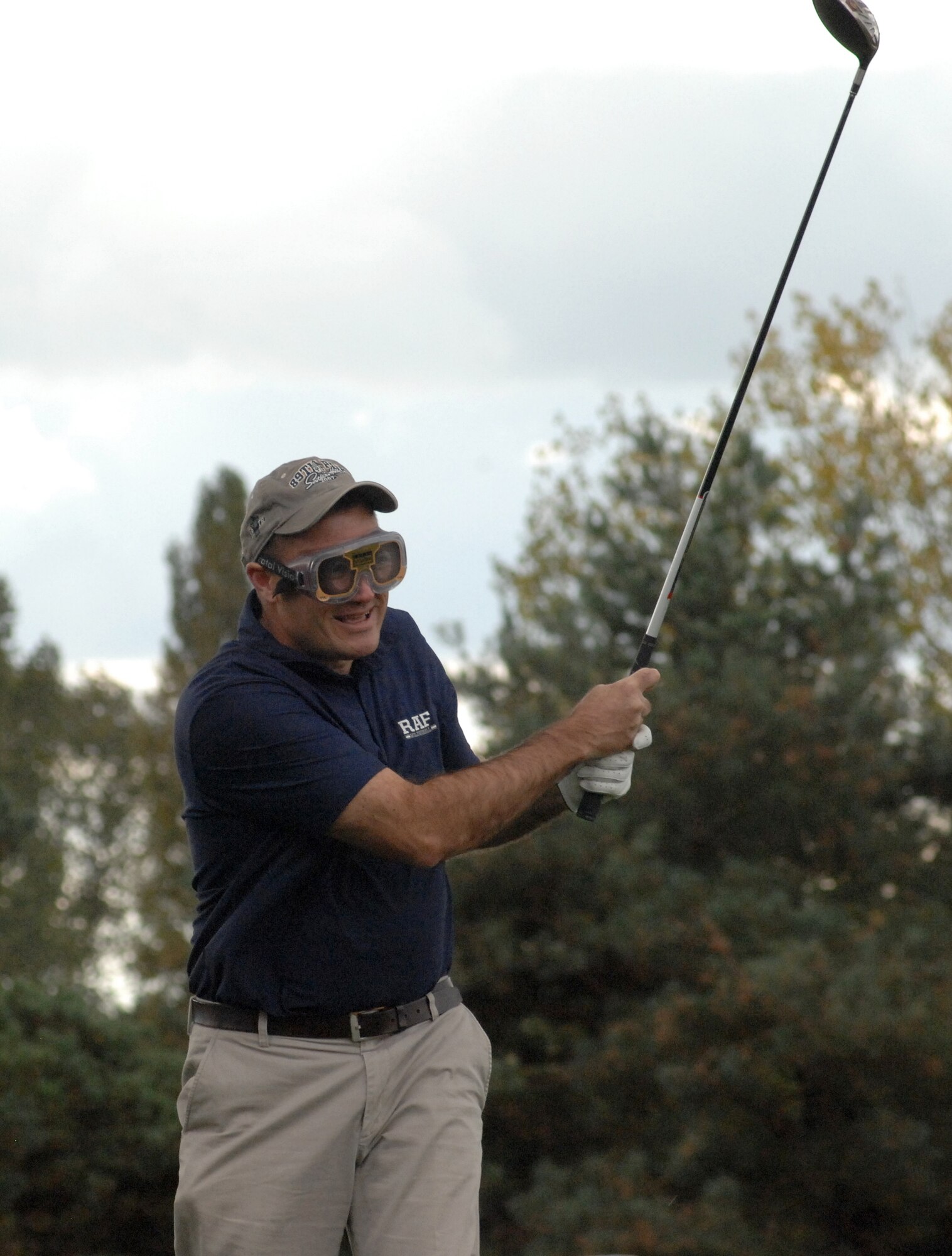 U.S. Air Force Col. Kenneth T. Bibb Jr., 100th Air Refueling Wing commander, drives off the 390-yard par 4, third hole wearing beer goggles at the Chiefs vs. Eagles Golf Tournament Sept. 24, 2014, at the Breckland Pines Golf Club on RAF Lakenheath, England. The golfers teamed up in pairs playing best-ball match play and the Eagles won the tournament three matches to one. (U.S. Air Force photo/Gary Rogers/Released)