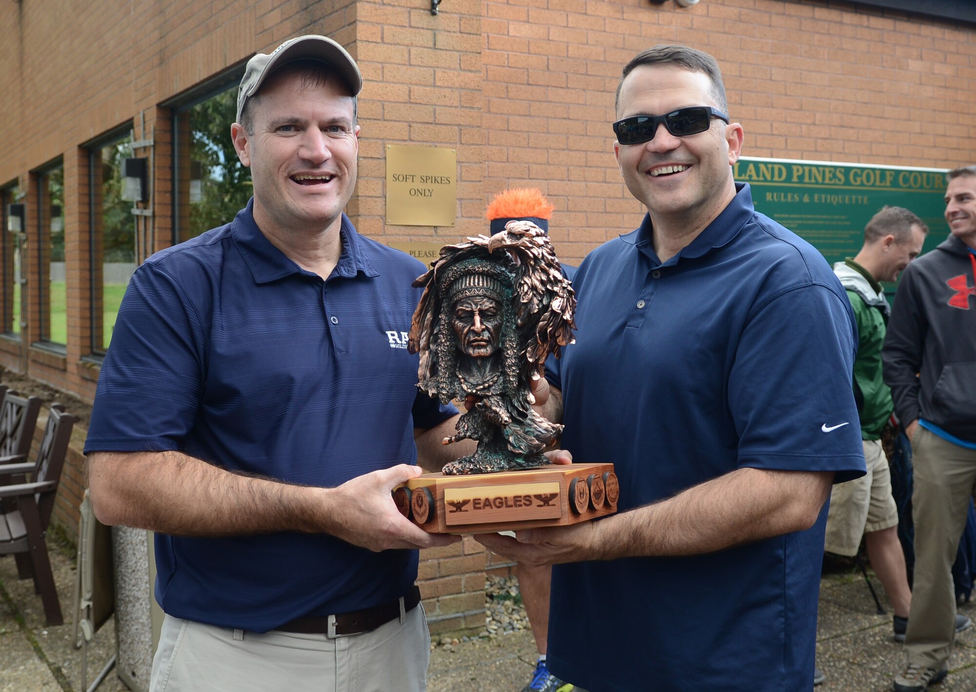 U.S. Air Force Col. Kenneth T. Bibb Jr., left, 100th Air Refueling Wing commander, and U.S. Air Force Chief Master Sgt. Brian Schexnider, 100th Logistics Readiness Squadron fuels manager, hold the Chiefs vs. Eagles trophy following the Chiefs vs. Eagles golf tournament Sept. 24, 2014, at the Breckland Pines Golf Club on RAF Lakenheath, England. The tournament was comprised of not only colonels and chief master sergeants, but various commanders and first sergeants from around base. (U.S. Air Force photo/Airman 1st Class Dillon Johnston/Released)