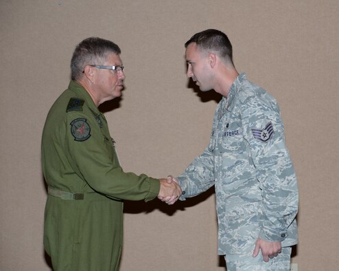 Lieutenant-General Alain Parent, North American Aerospace Defense Command deputy commander, recognizes Staff Sgt. Lance Allen, a member of the 601st Air and Space Operations Center Intelligence, Surveillance and Reconnaissance Division, with a coin during a recent visit to the 601st AOC at Tyndall Air Force Base, Fla. Sept. 24, 2014. Parent's visit included talks with Continental U.S. NORAD Region and AOC leadership as well as a stop by the AOC's operation floor to speak with members of the AOC. (Air National Guard photo by Lt. Col. Steve Burke/Released)