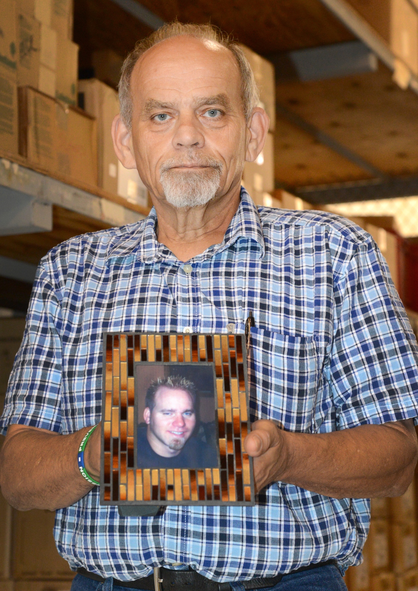 Billy “Rocky” Dunham, with the 552nd Commodities Maintenance Squadron, holds a photograph of his son, Joey, who died six years ago at the age of 27 from suicide. Since then, Mr. Dunham and his wife have been staunch advocates of suicide prevention and depression awareness and want people to educate themselves on the signs and symptoms, including withdrawal, reckless behavior and negative verbal statements. Those in need of help can call 1-800-SUICIDE or 1-800-273-TALK. (Air Force photo by Kelly White)