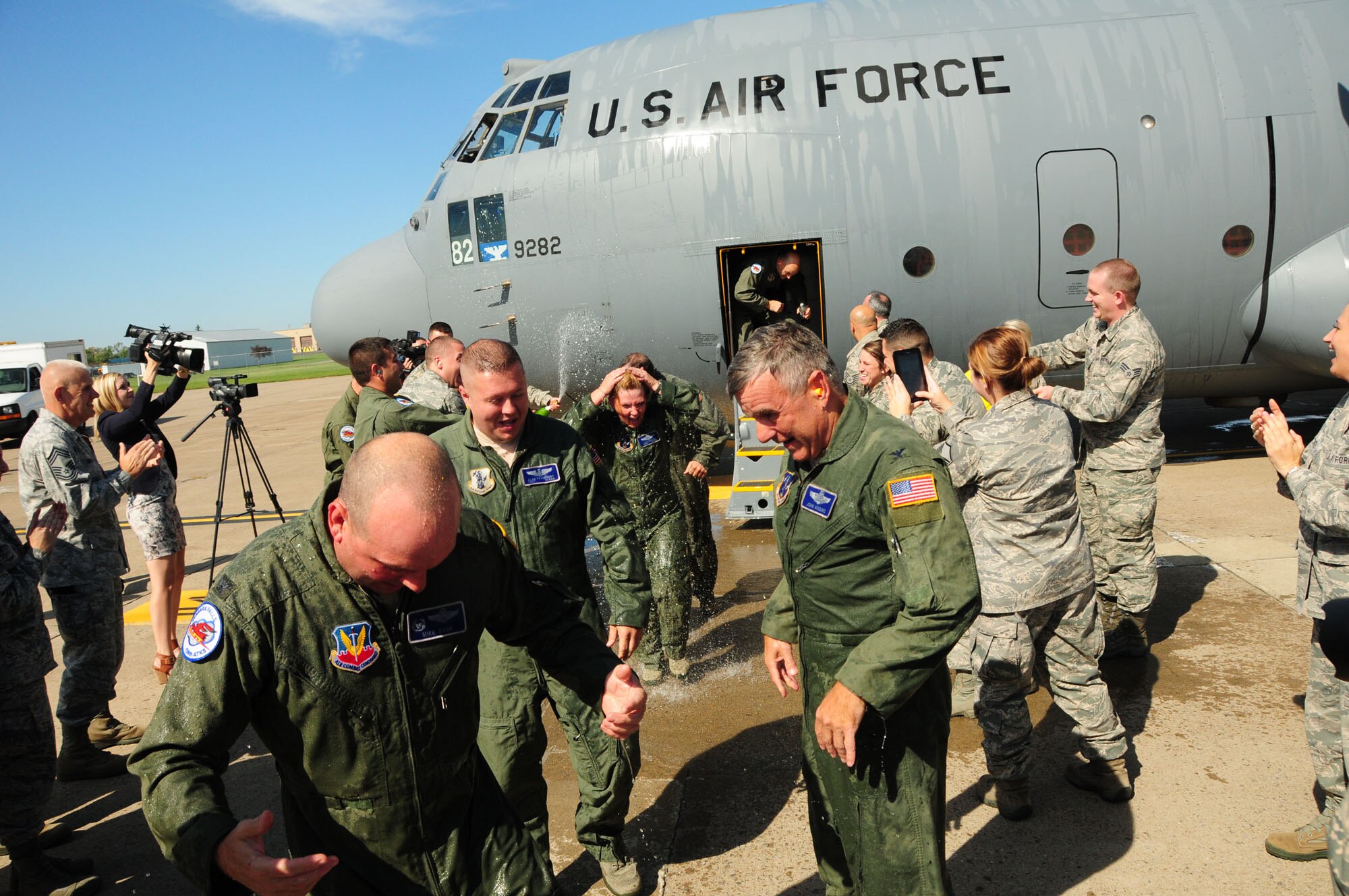The aircrew from the New York Air National Guard's 107th Airlift Wing is doused after stepping off a C-130 for the last time, a tradition after a "fini flight" on Thursday, Sept. 25, 2014. It was the last C-130 flight for the 107th Airlift Wing at the Niagara Falls Air Reserve Station as it converts to MQ-9 operations. (U.S. Air National Guard Photo by Senior Master Sgt. Raymond Lloyd/Released)