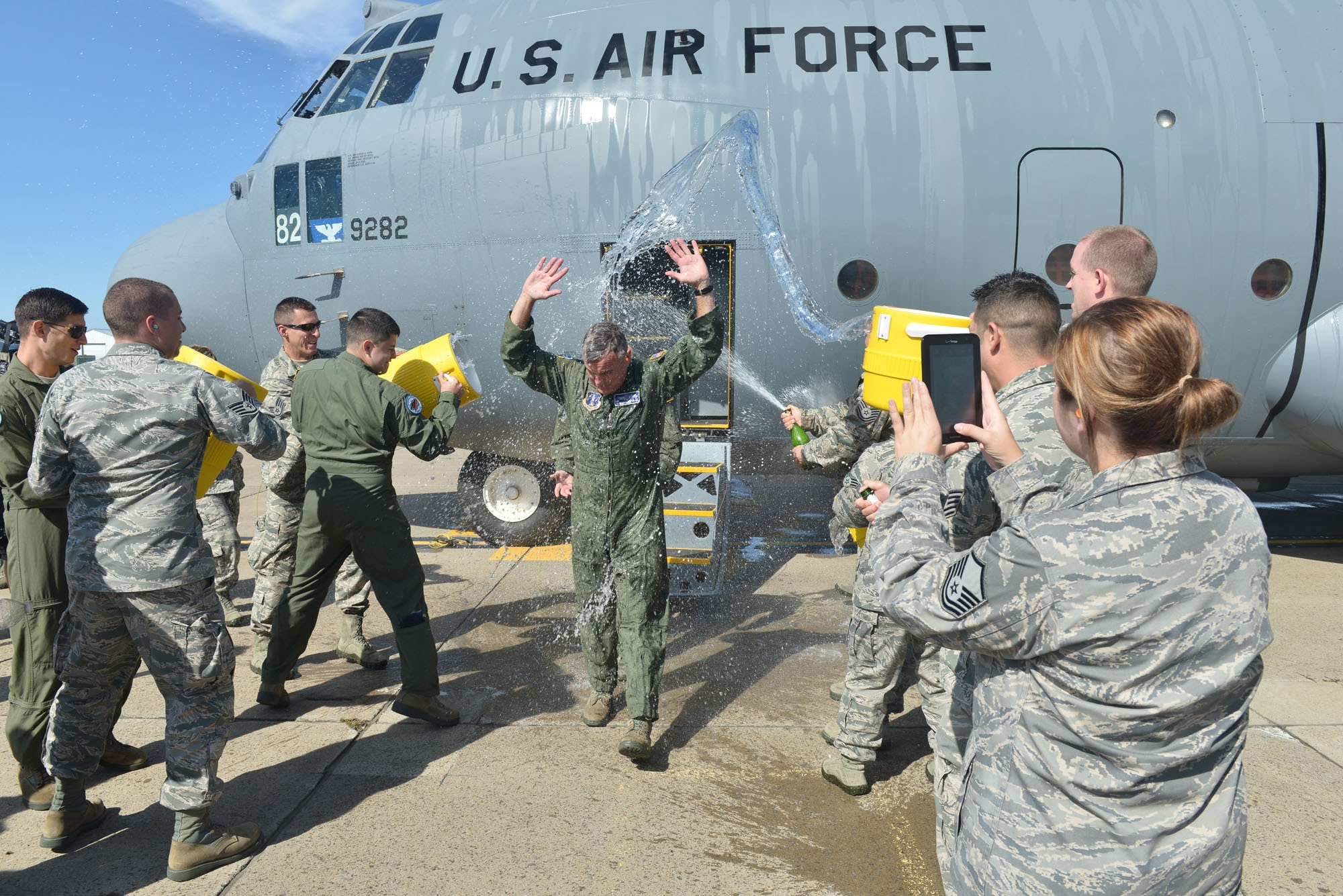 New York Air National Guard Col. John J. Higgins, commander of the 107th Airlift Wing, is doused by his comrades as he steps off of the aircraft following his "fini flight," his final flight as a navigator. It was the 107th Airlift Wing's final flight in a C-130 before converting to the MQ-9 mission. (U.S. Air National Guard Photo/Staff Sgt. Ryan Campbell)
