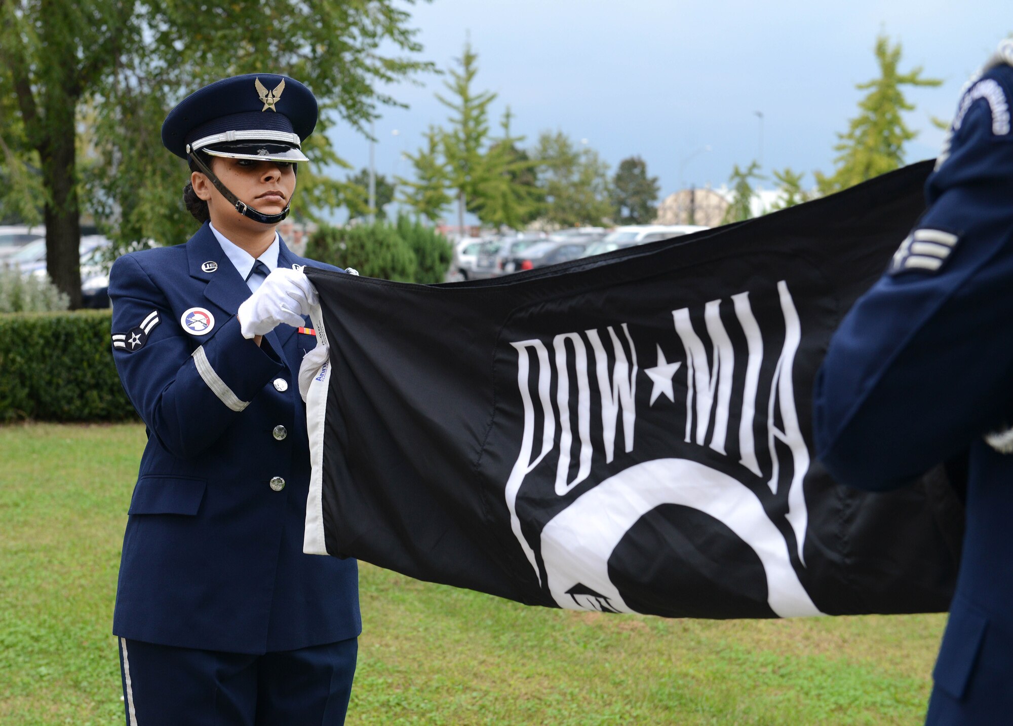 Airman 1st Class Ninoshka Rivas-Perez, 31st Force Support Squadron Honor Guard member, folds the Prisoner of War/Missing in Action flag during a retreat ceremony, Sept. 25, 2014, at Aviano Air Base, Italy. The ceremony concluded the weeks event with a formal folding of the American and POW/MIA flags and comments by the vice commander. (U.S. Air Force photo/Airman 1st Class Deana Heitzman