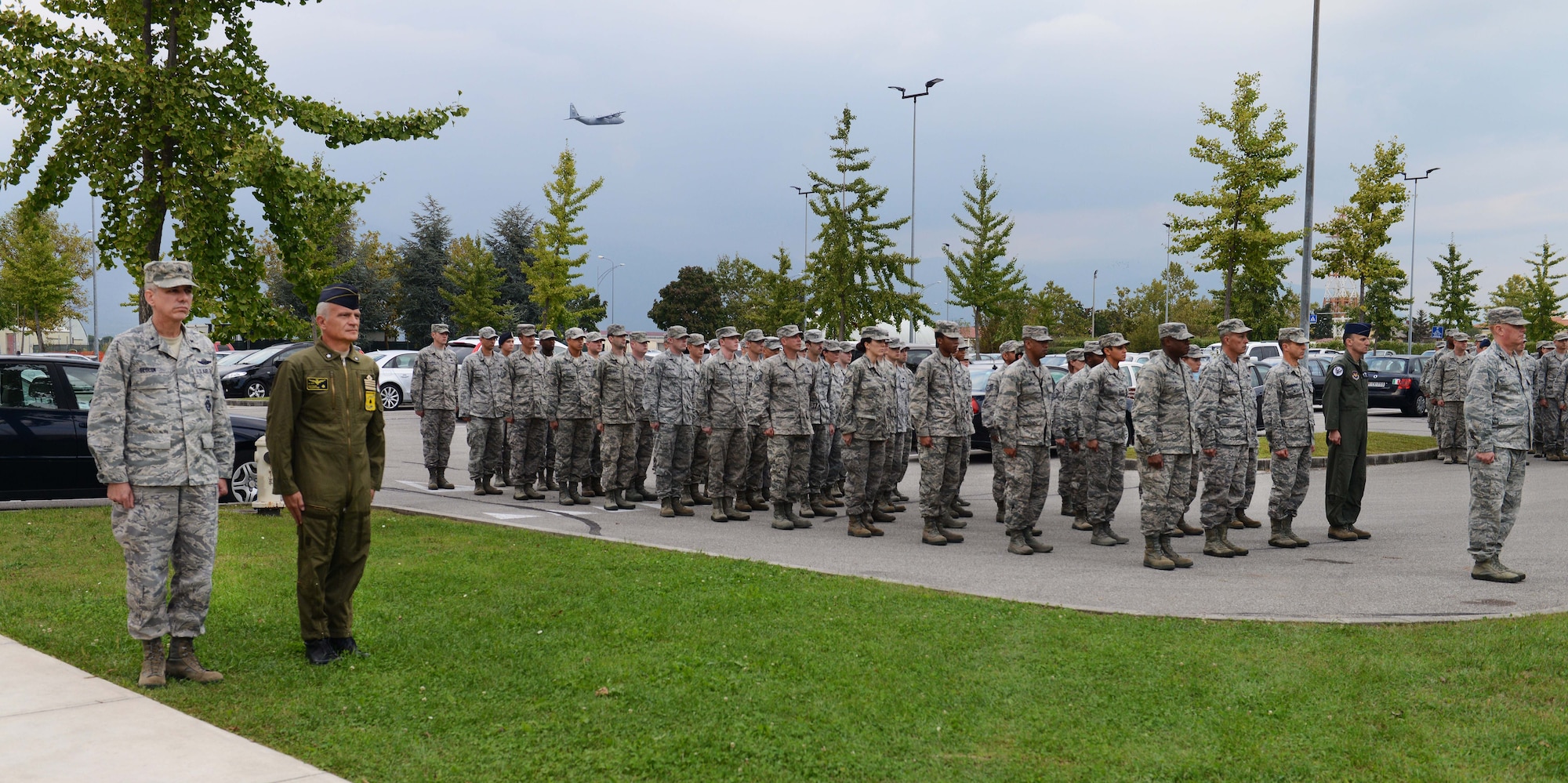 Brig. Gen. Barre Seguin, 31st Fighter Wing commander, Col. Valentino Savoldi, Pagliano e Gori Airport commander, and a formation of Airmen stand at attention during a retreat ceremony, Sept. 25, 2014.The ceremony concluded the weeks events with a formal folding of the American and POW/MIA flags and comments by the vice commander. (U.S. Air Force photo/Airman 1st Class Deana Heitzman)