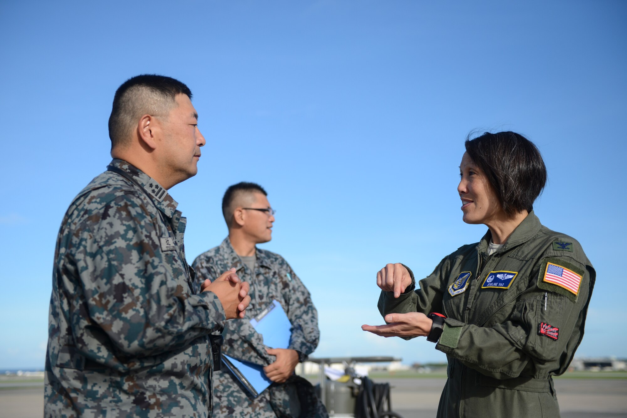 U.S. Air Force Col. Eveline Yao speaks with Japan Air Self-Defense Force Col. Tetsuya Tsujimoto before observing C-12 aeromedical evacuation training at Kadena Air Base, Japan, Sept. 24, 2014. Yao is the 374th Medical Group commander at Yokota Air Base, Japan, and Tetsuya is the commander of a JASDF Aeromedical Evacuation Squadron. U.S. military and JASDF often share military capabilities to improve their standing relationship. (U.S. Air Force photo by Staff Sgt. Cody H. Ramirez/Released) 