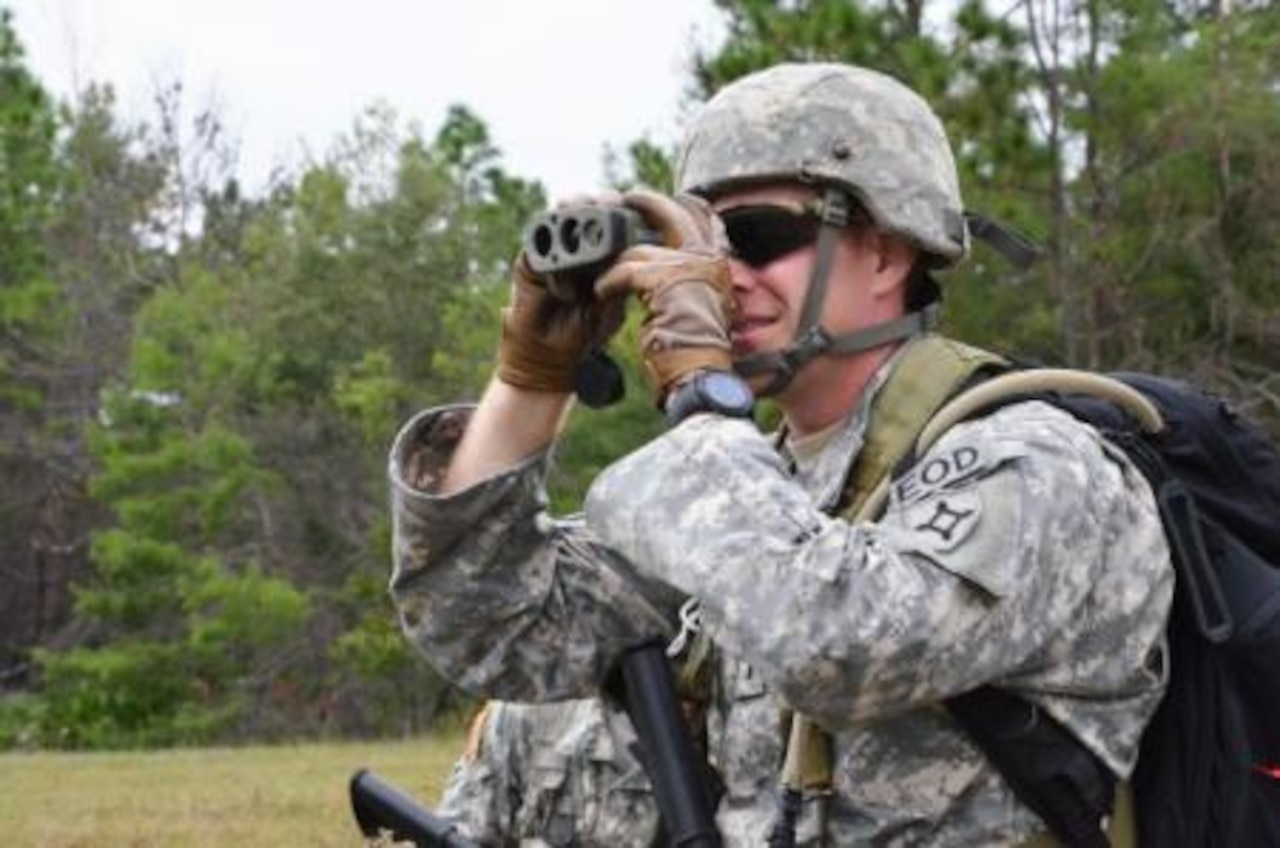 1st Lt. Thomas Ashlock of the Florida Army National Guard's 221st Explosive Ordnance Disposal unit assists his team in establishing a drop zone during the Pathfinder Course at Camp Blanding Joint Training Center, Fla., Sept. 24, 2014. U.S. Army photo by Master Sgt. Thomas Kielbasa